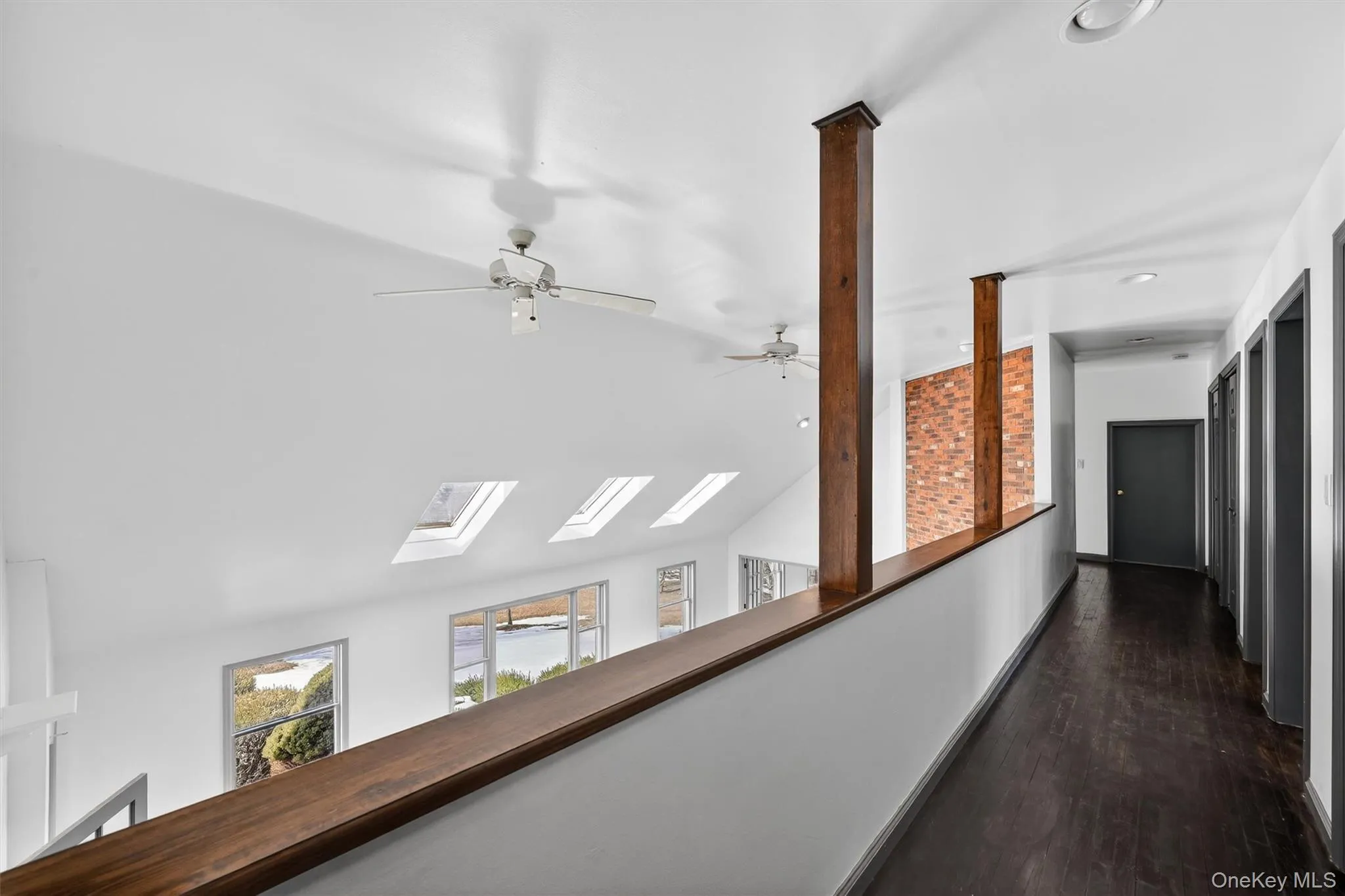 Open to the living room below, the second level hallway has a modern vibe Open to the living room below, the second level hallway has a modern vibe