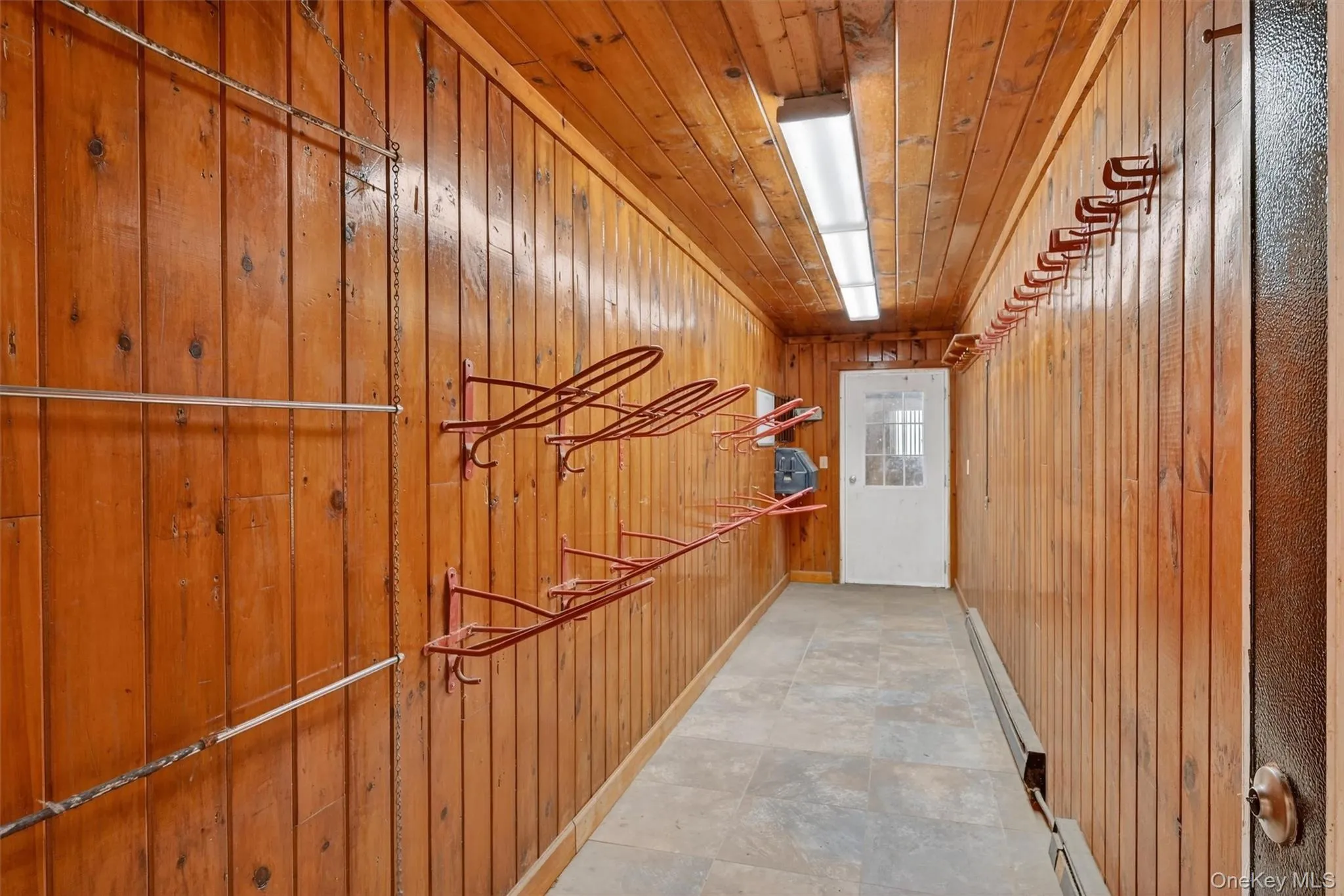 Heated tack room in main barn is accessible from both barn aisles. Heated tack room in main barn is accessible from both barn aisles.