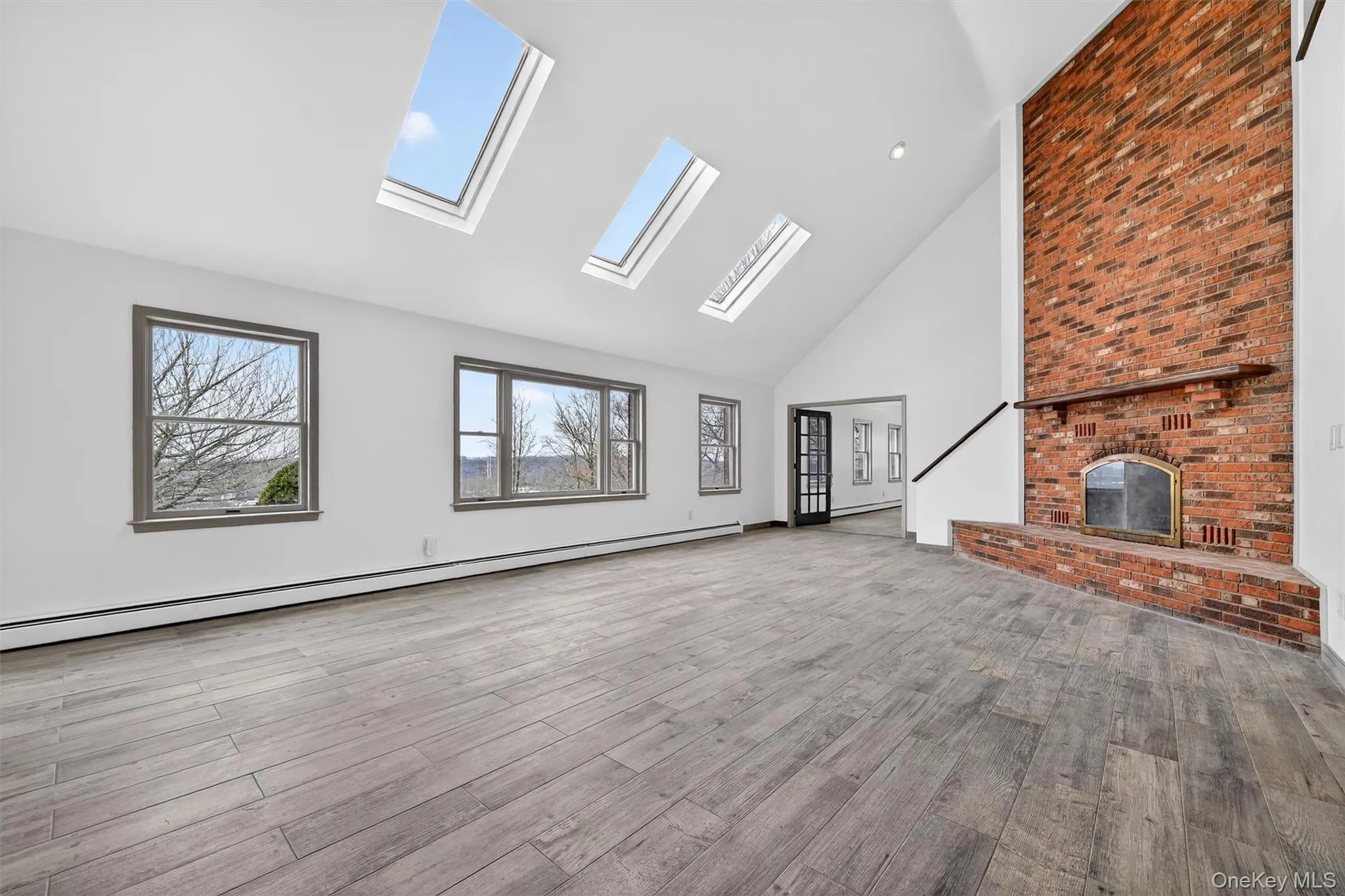 Large windows and skylights enhance the living room with tons of natural light Large windows and skylights enhance the living room with tons of natural light