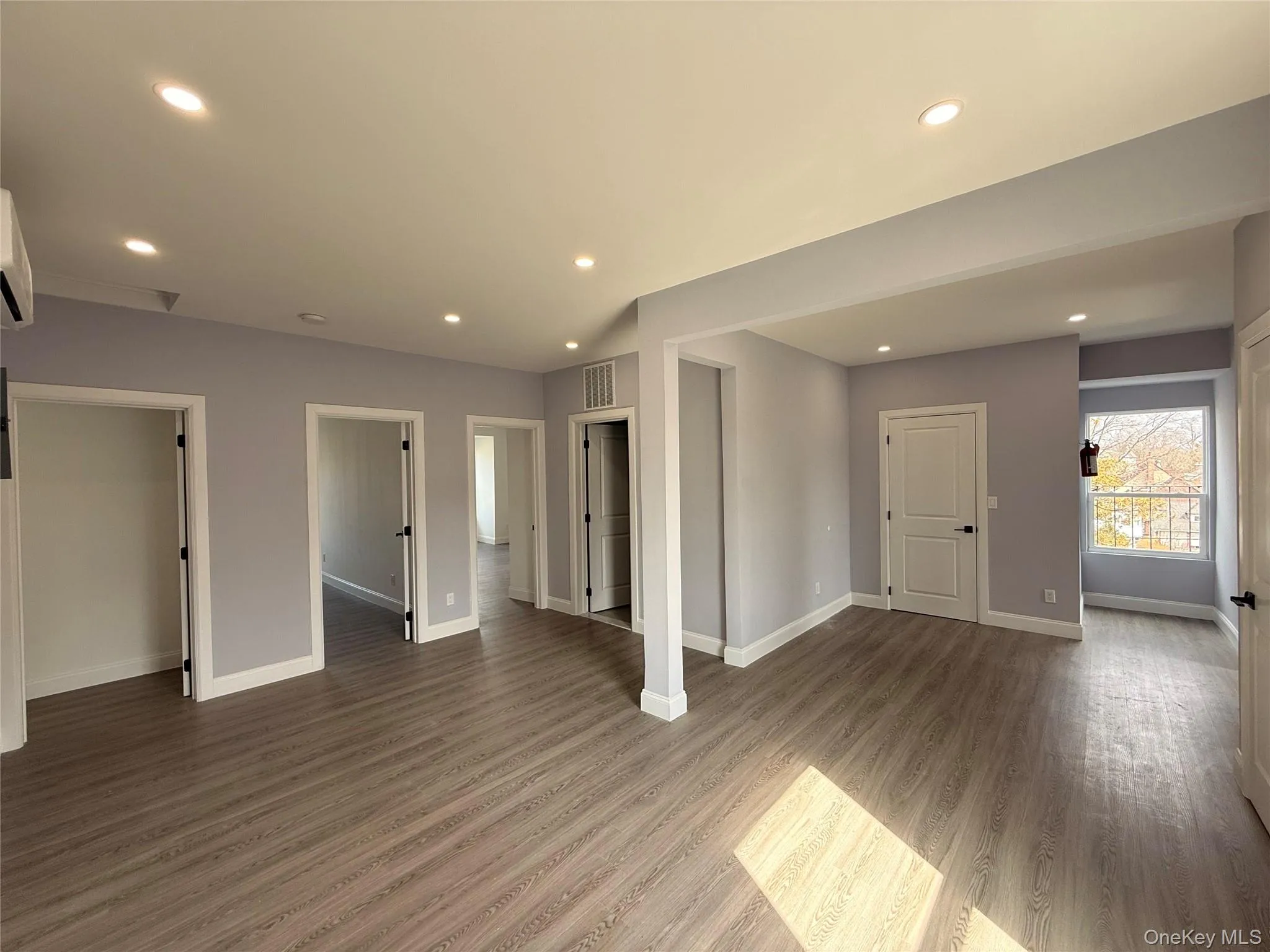 Living room with recessed lighting and dark wood-style floors Living room with recessed lighting and dark wood-style floors