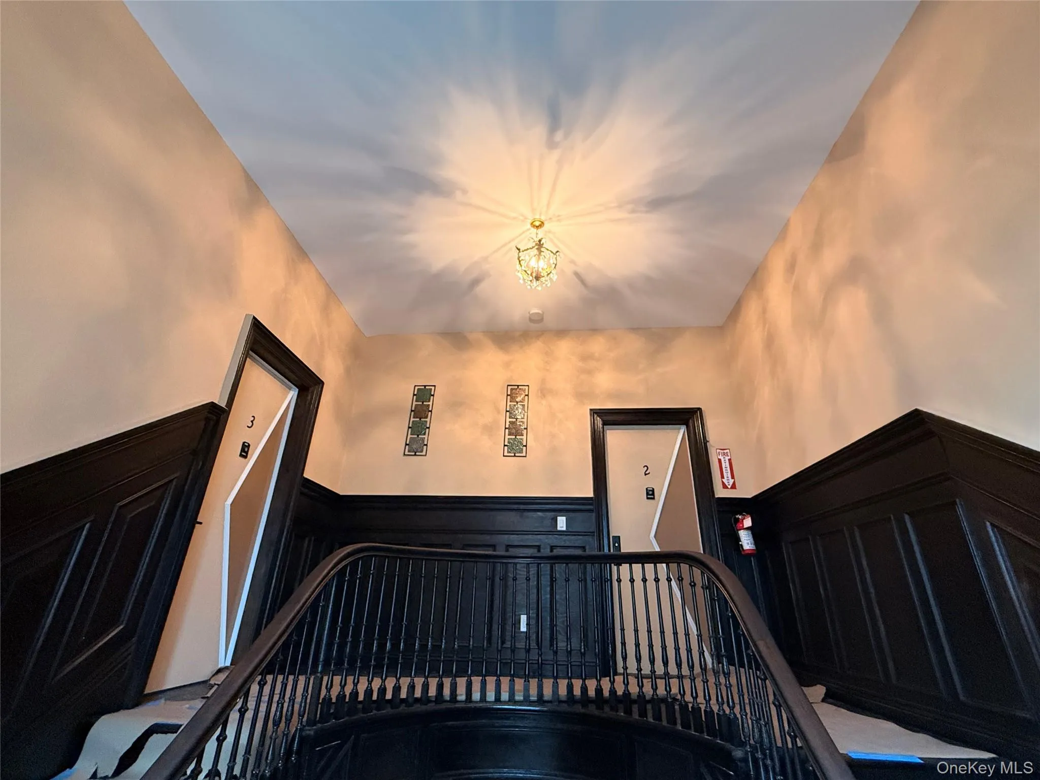 Stairs with wainscoting and a decorative wall Stairs with wainscoting and a decorative wall