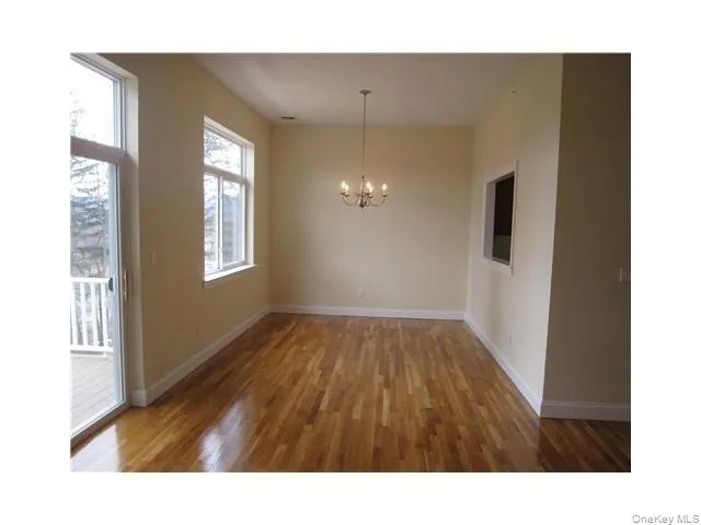 Large living room with high ceilings, oak floors and sliders to a trex deck Large living room with high ceilings, oak floors and sliders to a trex deck