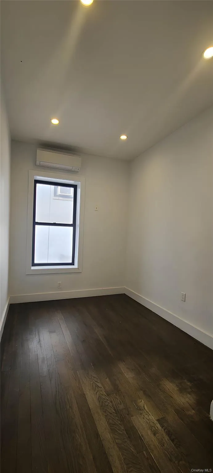 Unfurnished room with dark wood-style floors and recessed lighting Unfurnished room with dark wood-style floors and recessed lighting