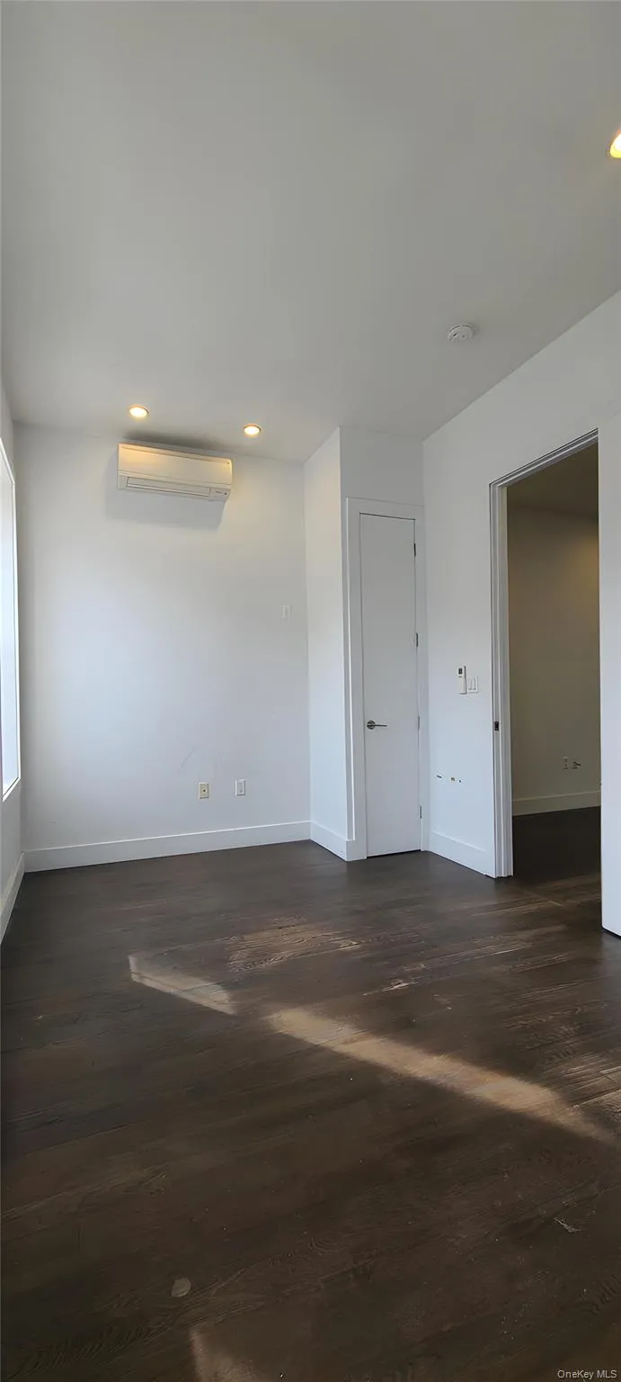 Unfurnished room featuring dark wood finished floors and recessed lighting Unfurnished room featuring dark wood finished floors and recessed lighting