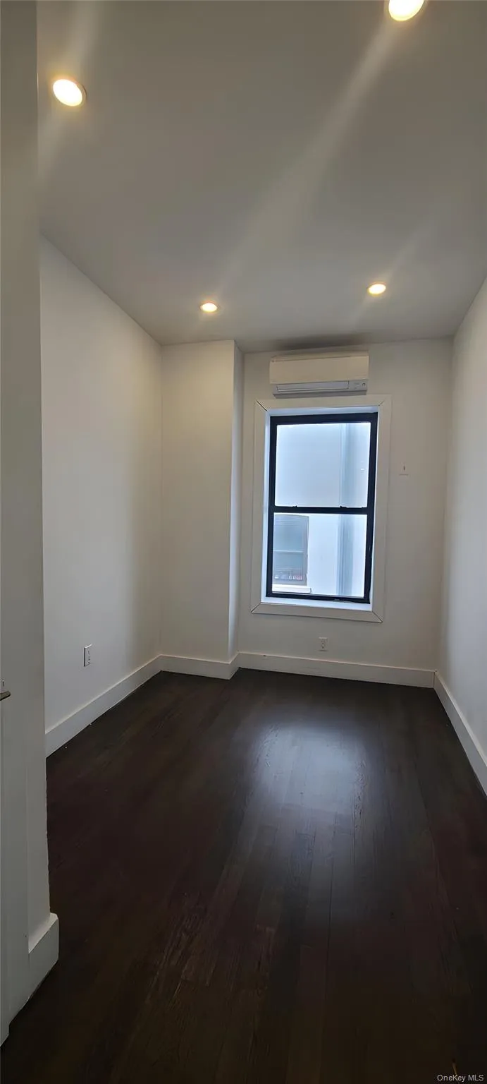 Spare room with dark wood-type flooring and recessed lighting Spare room with dark wood-type flooring and recessed lighting