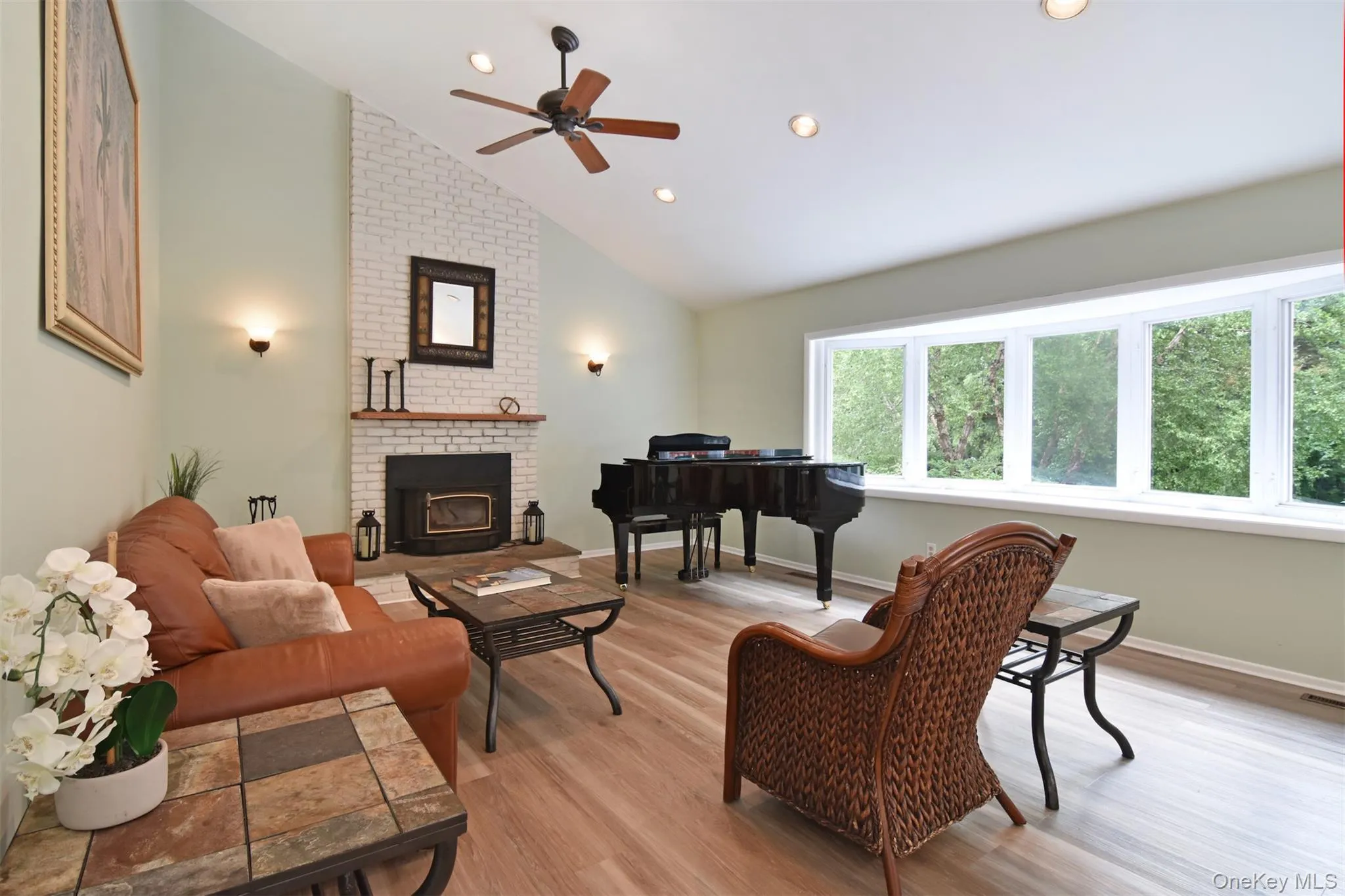 A short flight of stairs leads to a vast open plan space where living, dining, and kitchen areas flows seamlessly into one another in an inspiring, contemporary arrangement. A wood burning stove anchors the living room. A short flight of stairs leads to a vast open plan space where living, dining, and kitchen areas flows seamlessly into one another in an inspiring, contemporary arrangement. A wood burning stove anchors the living room.