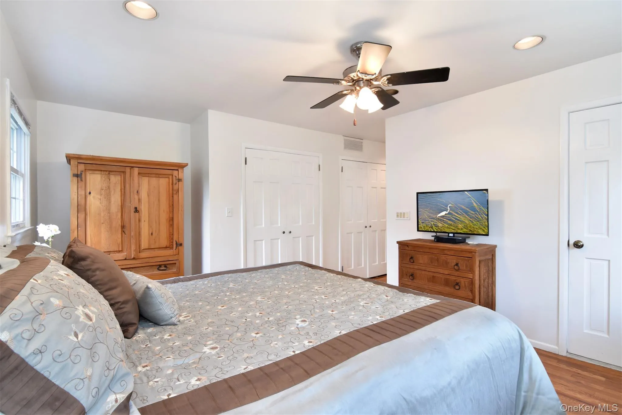 The king-sized primary bedroom suite has windows on two sides with plenty of closets. The king-sized primary bedroom suite has windows on two sides with plenty of closets.