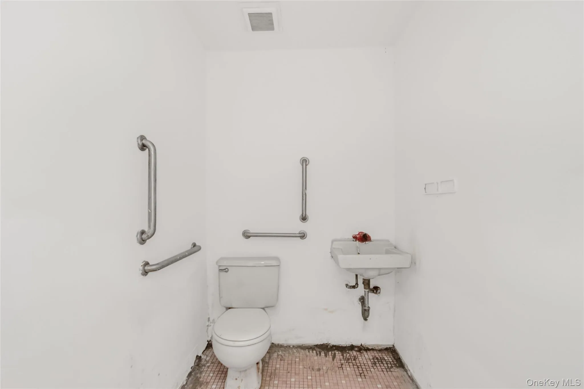 Half bath with tile patterned flooring, visible vents, and toilet Half bath with tile patterned flooring, visible vents, and toilet