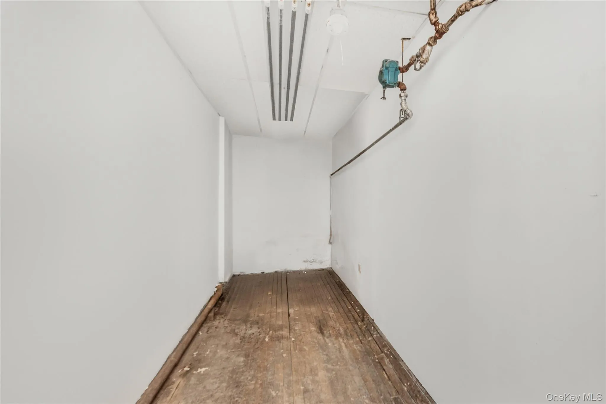 Hallway featuring hardwood / wood-style floors Hallway featuring hardwood / wood-style floors