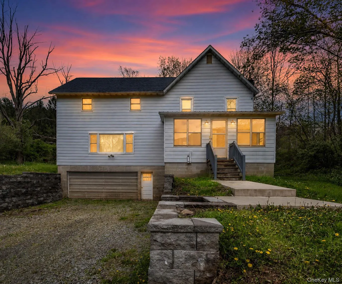 Two-story exterior with horizontal siding, featuring a covered front porch with steps and railings Two-story exterior with horizontal siding, featuring a covered front porch with steps and railings