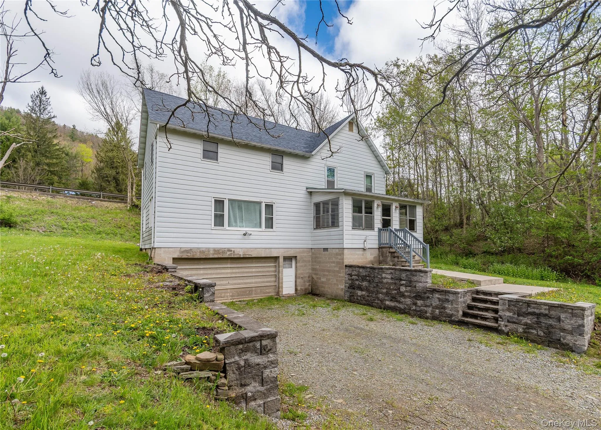 Two-story residence featuring white siding and a covered porch Two-story residence featuring white siding and a covered porch