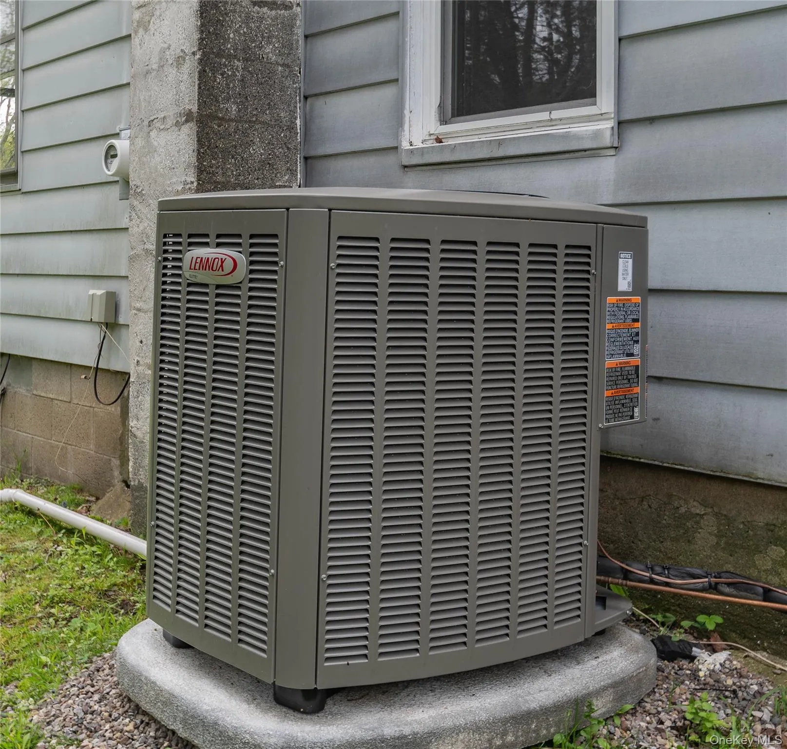 Exterior HVAC unit on a concrete pad Exterior HVAC unit on a concrete pad