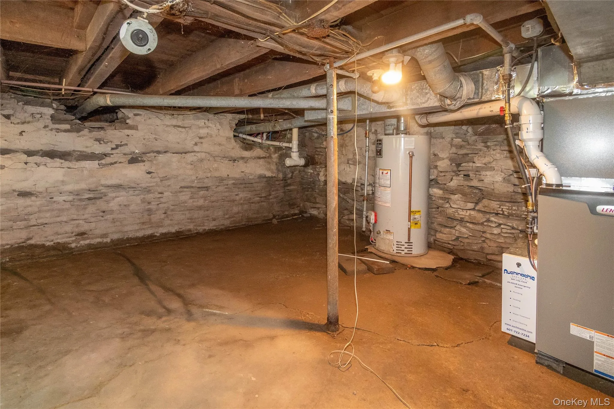 Unfinished basement featuring exposed wood ceiling joists and stone foundation walls Unfinished basement featuring exposed wood ceiling joists and stone foundation walls