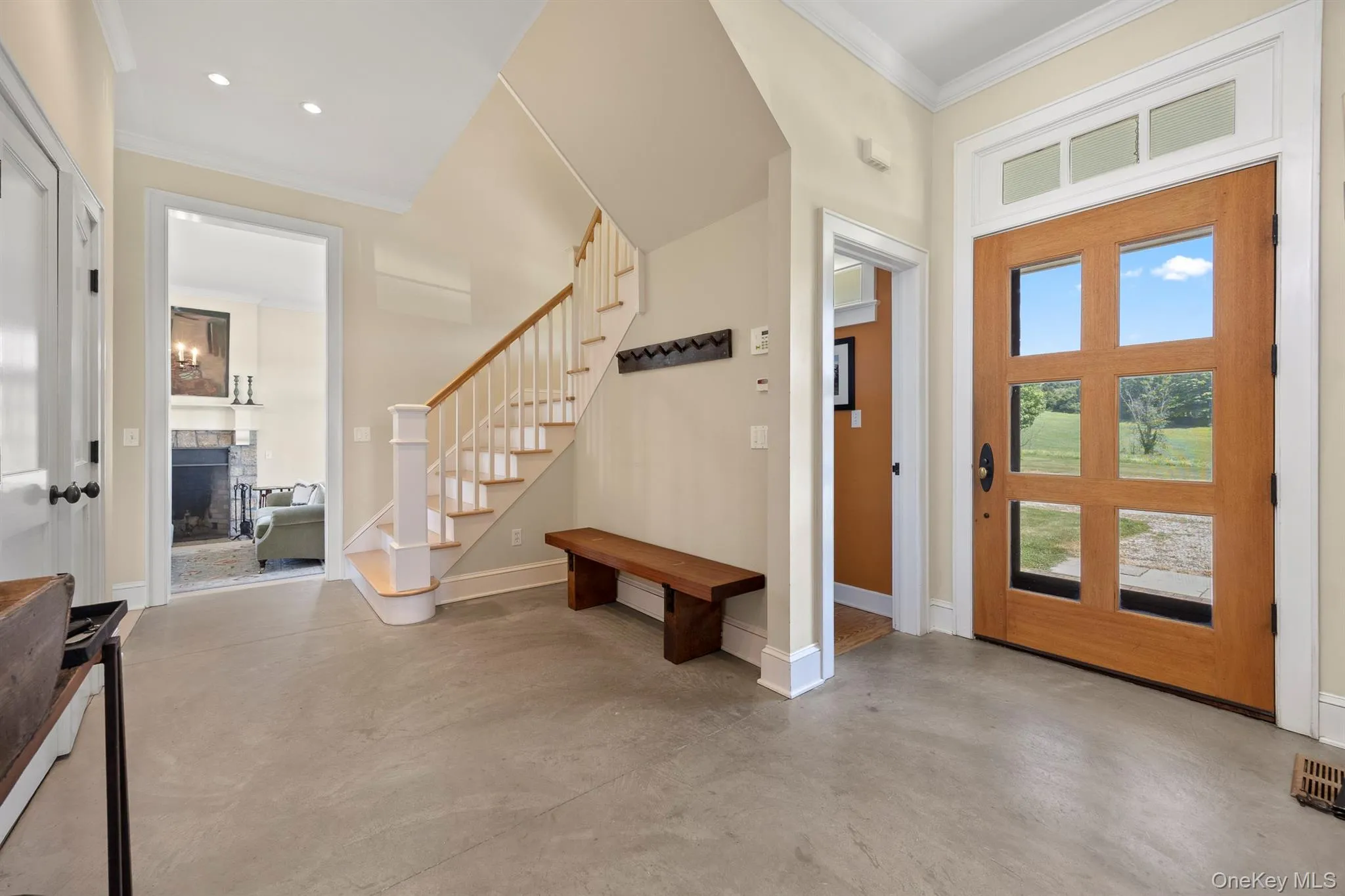 A Stunning Entrance with Polished Concrete Floor, Pegs to Hang Coats & Closets A Stunning Entrance with Polished Concrete Floor, Pegs to Hang Coats & Closets