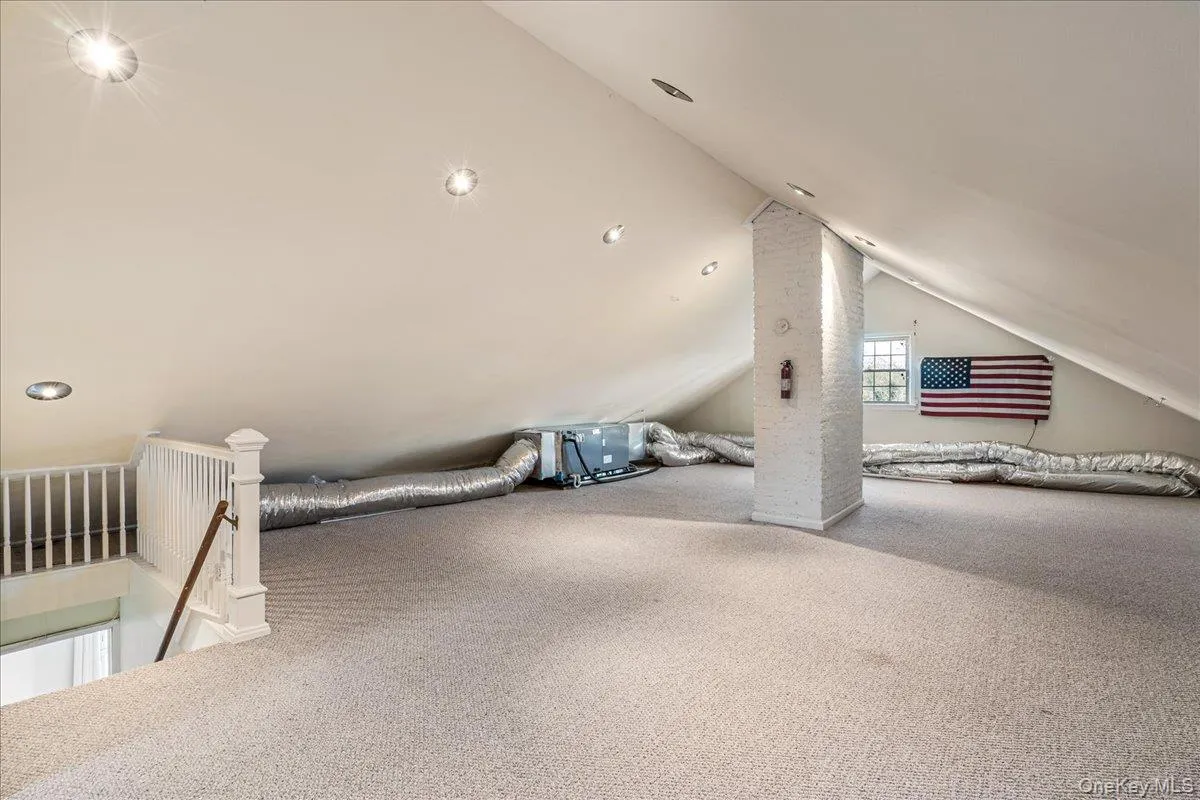 Walk-up attic with wall to wall carpeting. Walk-up attic with wall to wall carpeting.