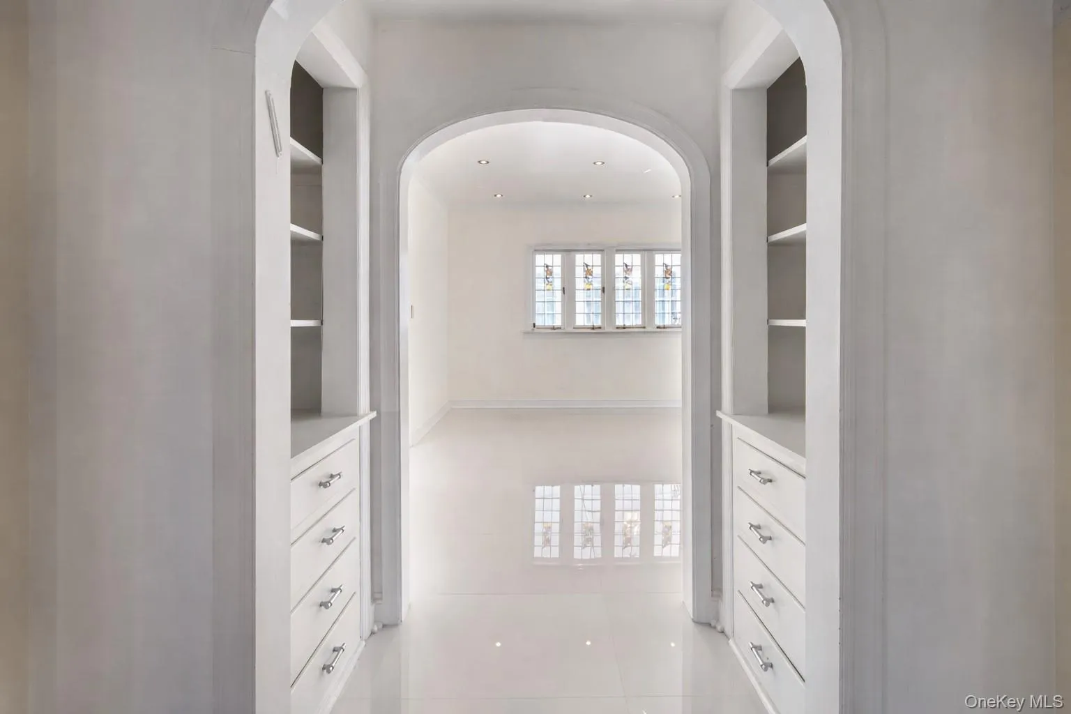 This arched pass-thru with original built-ins connects the entertaining spaces. This arched pass-thru with original built-ins connects the entertaining spaces.