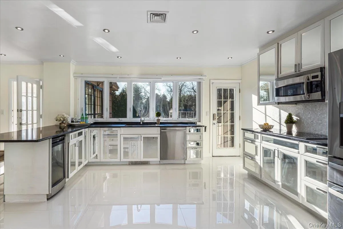 Gleaming kitchen with access to the brick terrace. Gleaming kitchen with access to the brick terrace.