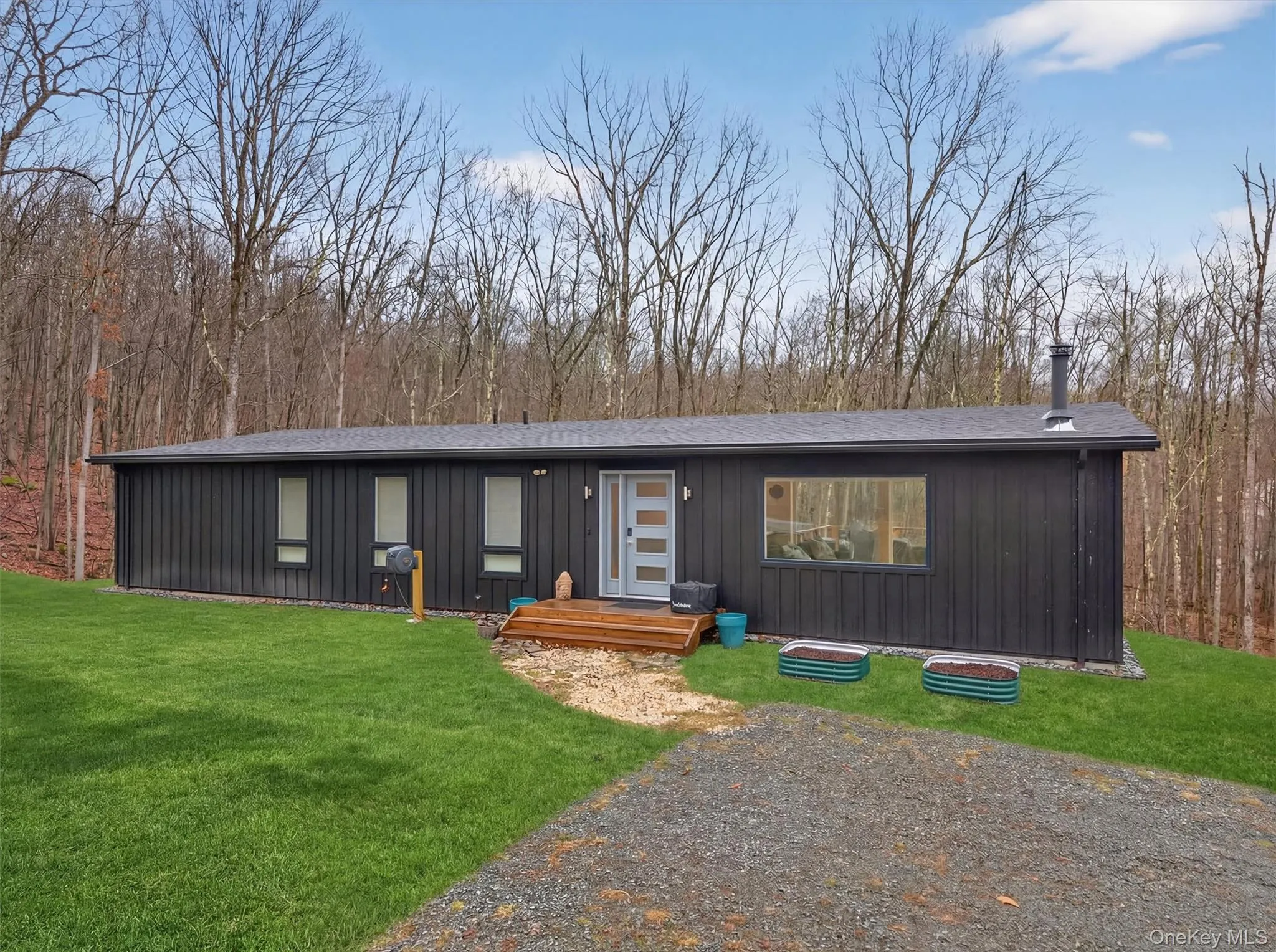 View of front facade featuring board and batten siding and a front lawn View of front facade featuring board and batten siding and a front lawn