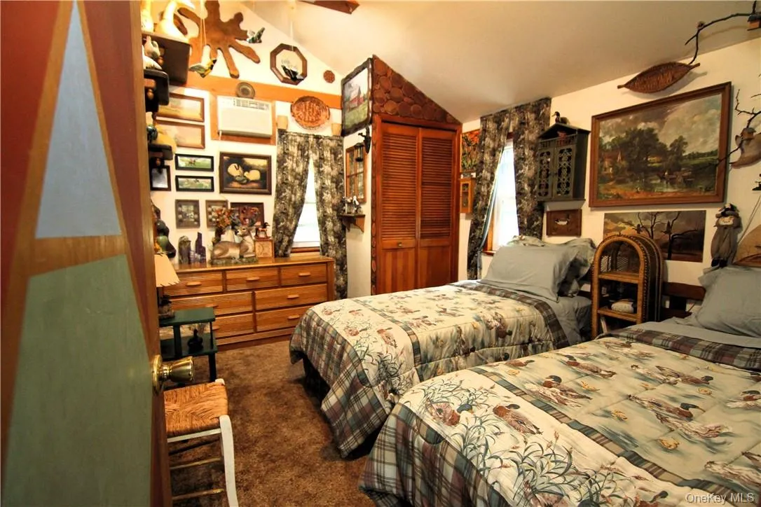 Carpeted bedroom featuring a closet and lofted ceiling Carpeted bedroom featuring a closet and lofted ceiling