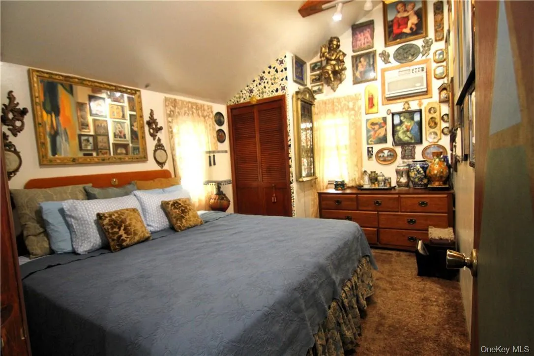 Bedroom featuring high vaulted ceiling and dark carpet Bedroom featuring high vaulted ceiling and dark carpet