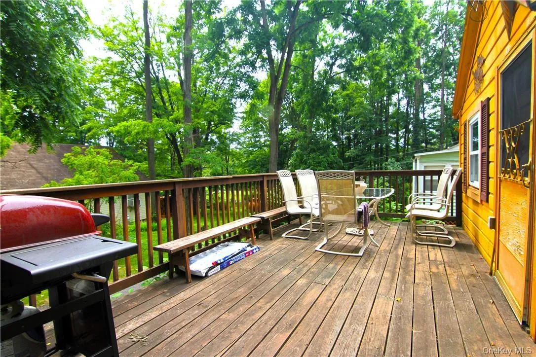 Wooden terrace featuring grilling area Wooden terrace featuring grilling area