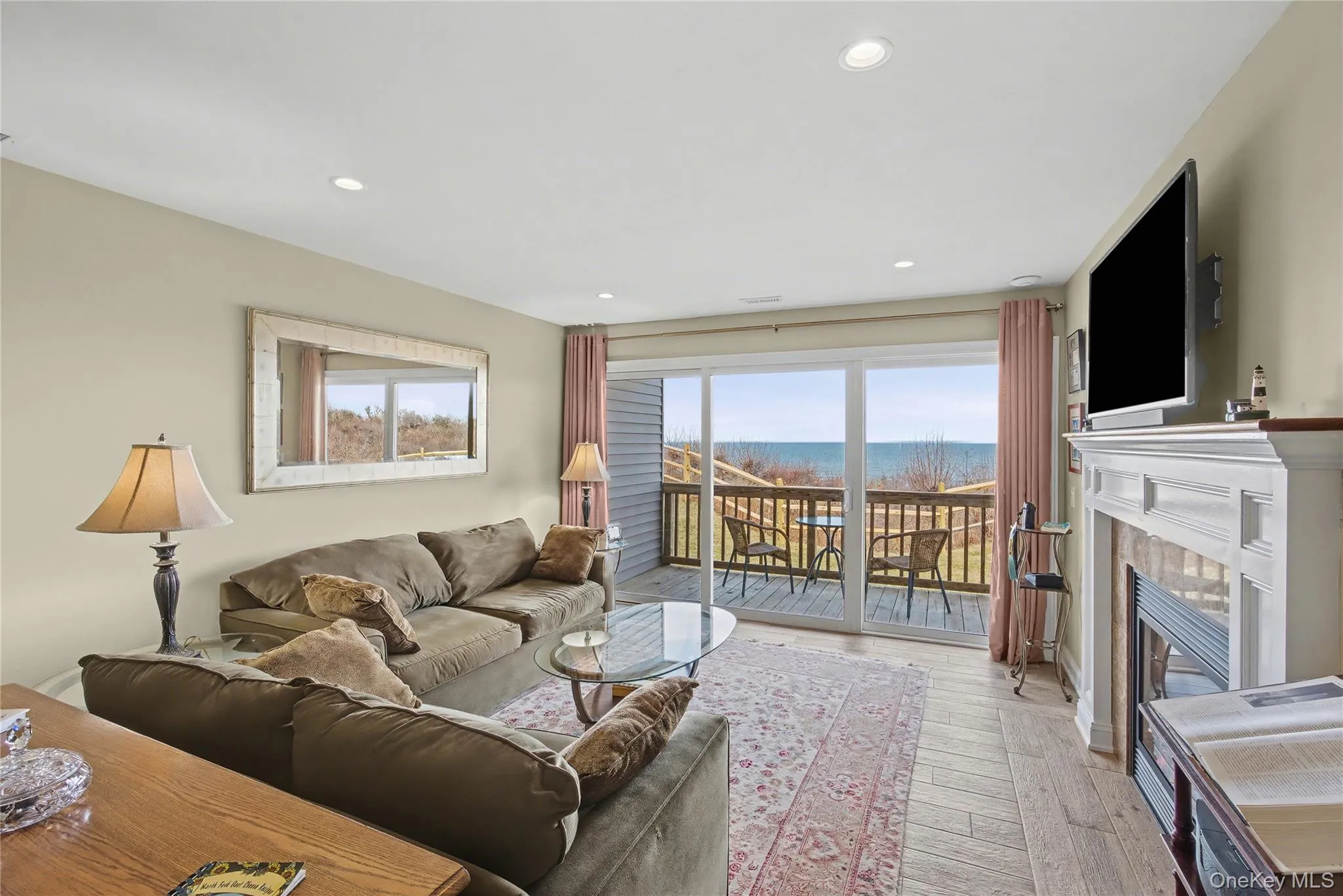 Living room with sliding glass doors to the deck and Long Island Sound Views. Living room with sliding glass doors to the deck and Long Island Sound Views.