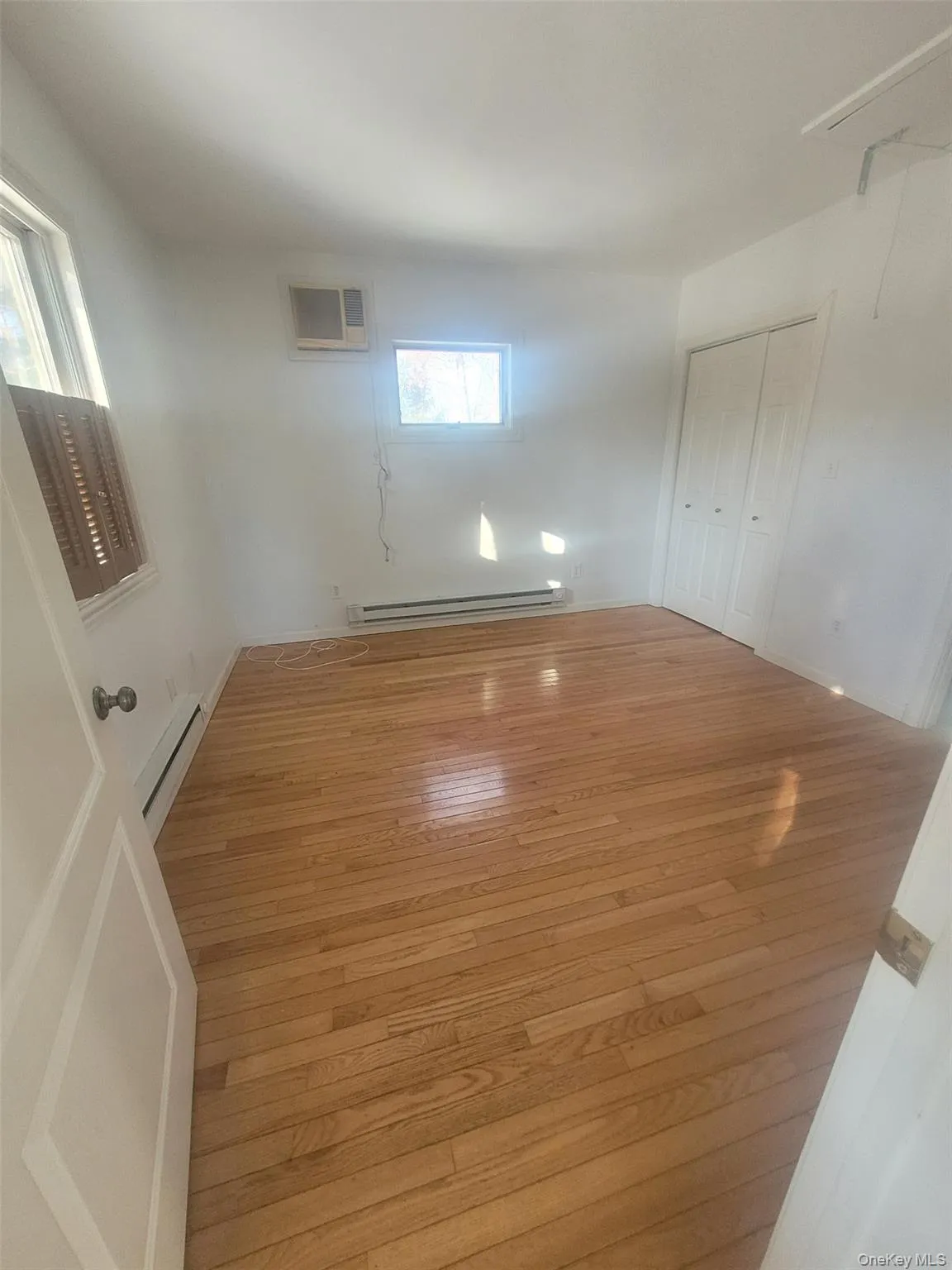 Empty bedroom with hardwood floors Empty bedroom with hardwood floors