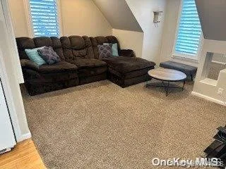 Living room with lofted ceiling and light wood-type flooring Living room with lofted ceiling and light wood-type flooring