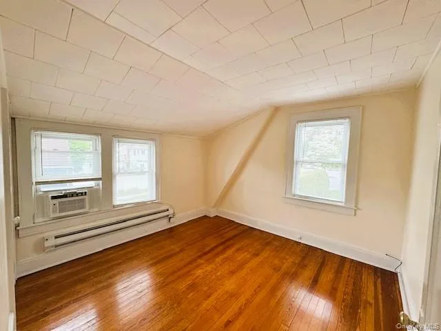 Hardwood flooring complemented by light-toned wall finishes and a textured ceiling Hardwood flooring complemented by light-toned wall finishes and a textured ceiling