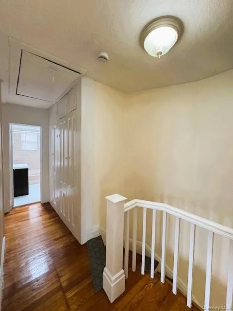 Hardwood flooring in a hallway with white paneled Linen and Storage Closets. Hardwood flooring in a hallway with white paneled Linen and Storage Closets.