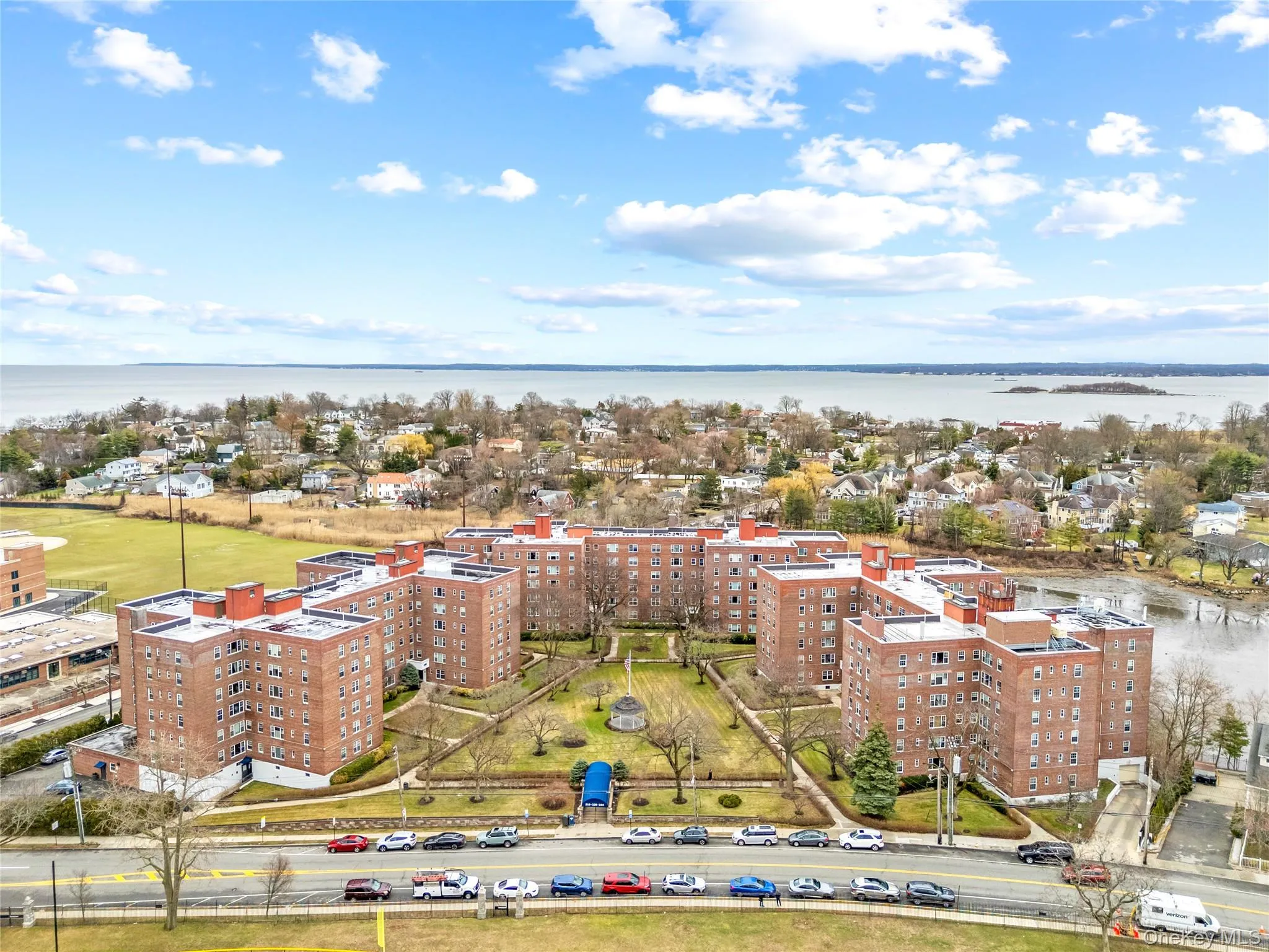 Drone / aerial view of a nearby body of water and apartment complex Drone / aerial view of a nearby body of water and apartment complex