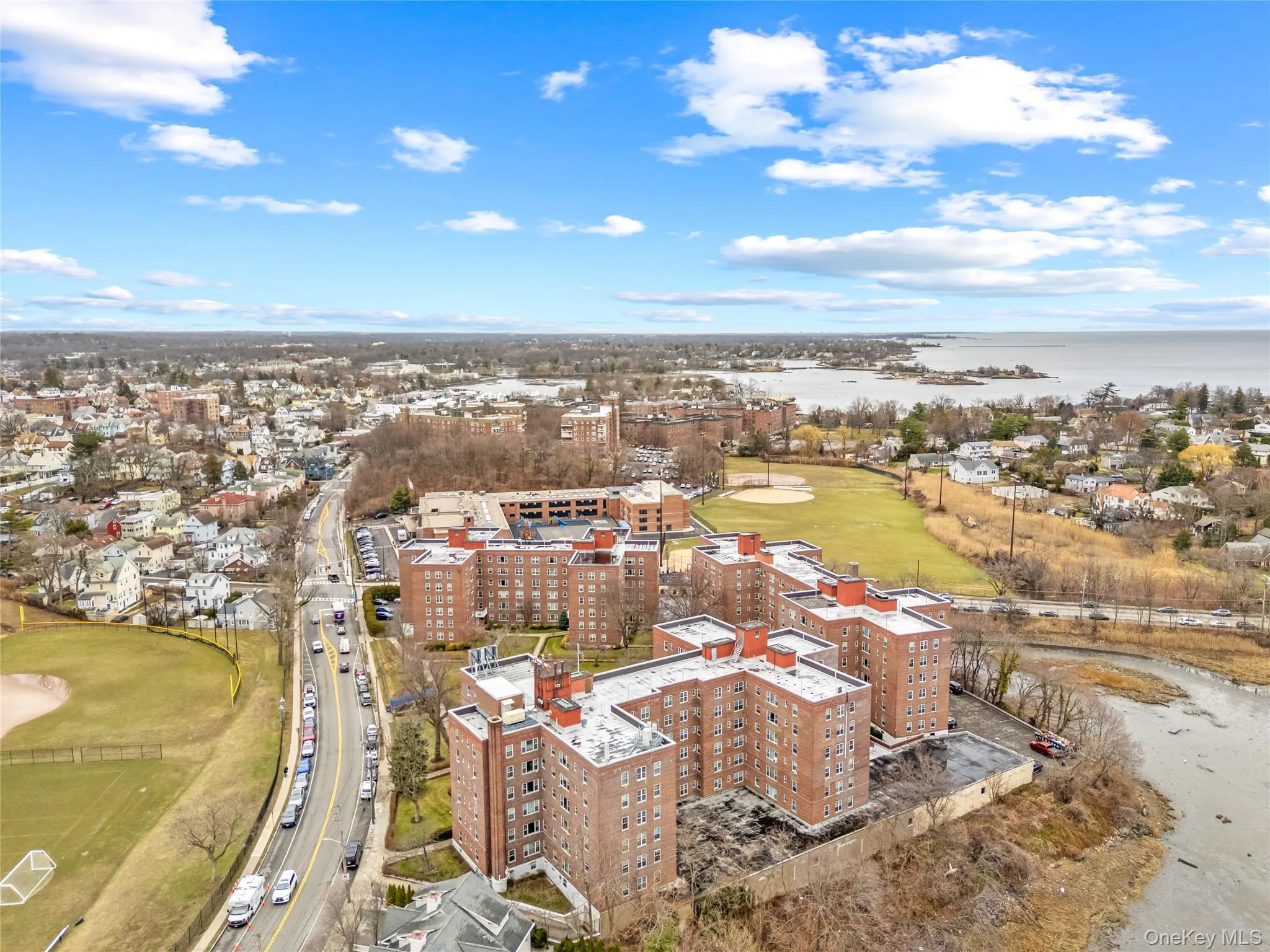 Aerial view of the building complex with scenic views of Hudson Park and Five Islands Park in the background, showcasing the property’s proximity to waterfront parks, green space, and coastal recreation. Aerial view of the building complex with scenic views of Hudson Park and Five Islands Park in the background, showcasing the property’s proximity to waterfront parks, green space, and coastal recreation.