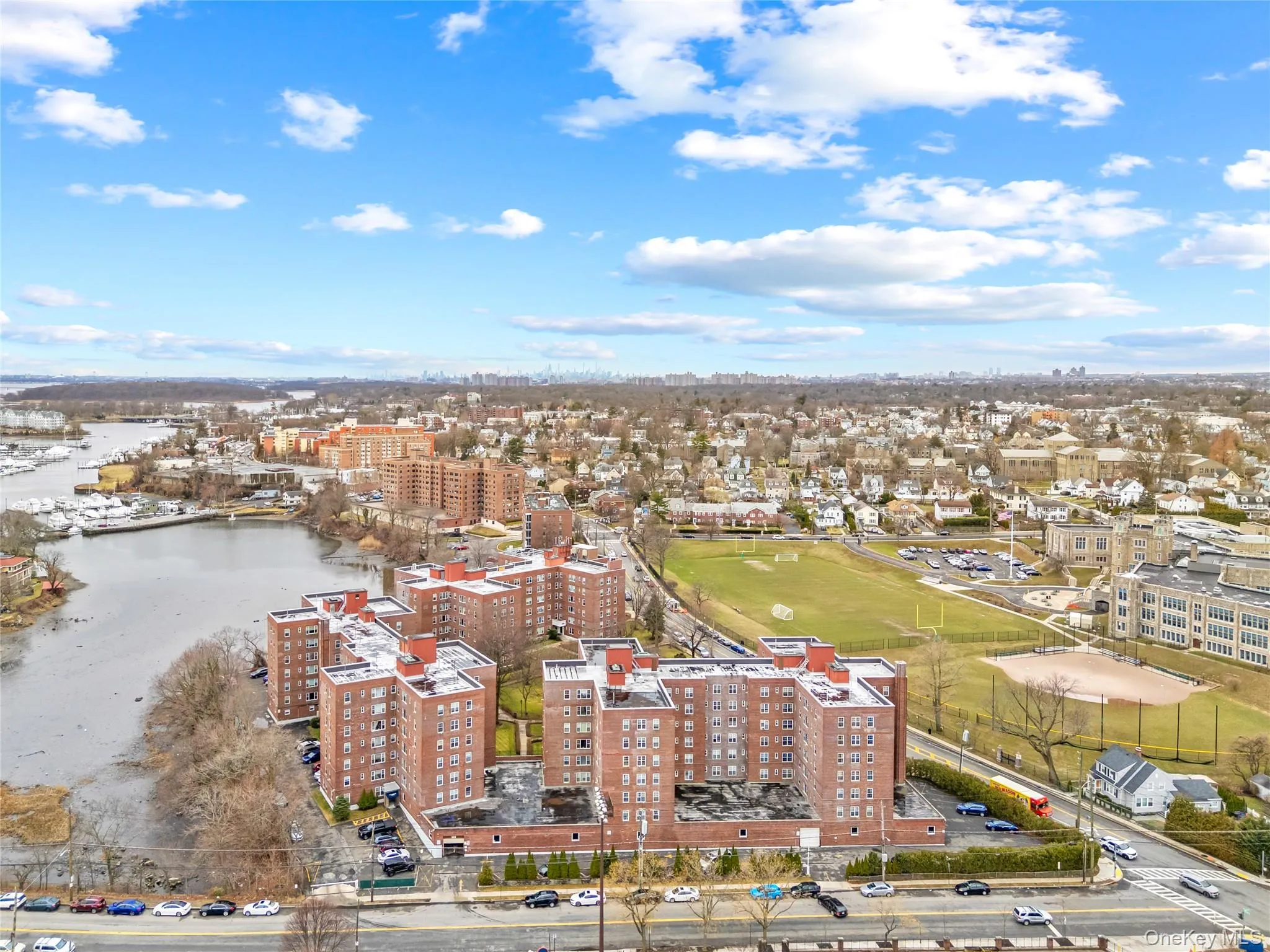 Aerial view showcasing the building’s prime waterfront setting with scenic views of the New York City skyline in the background. Aerial view showcasing the building’s prime waterfront setting with scenic views of the New York City skyline in the background.