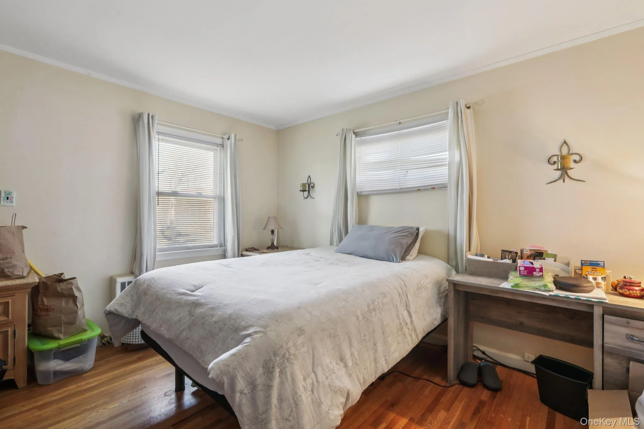 Bedroom with dark wood-type flooring and crown molding Bedroom with dark wood-type flooring and crown molding
