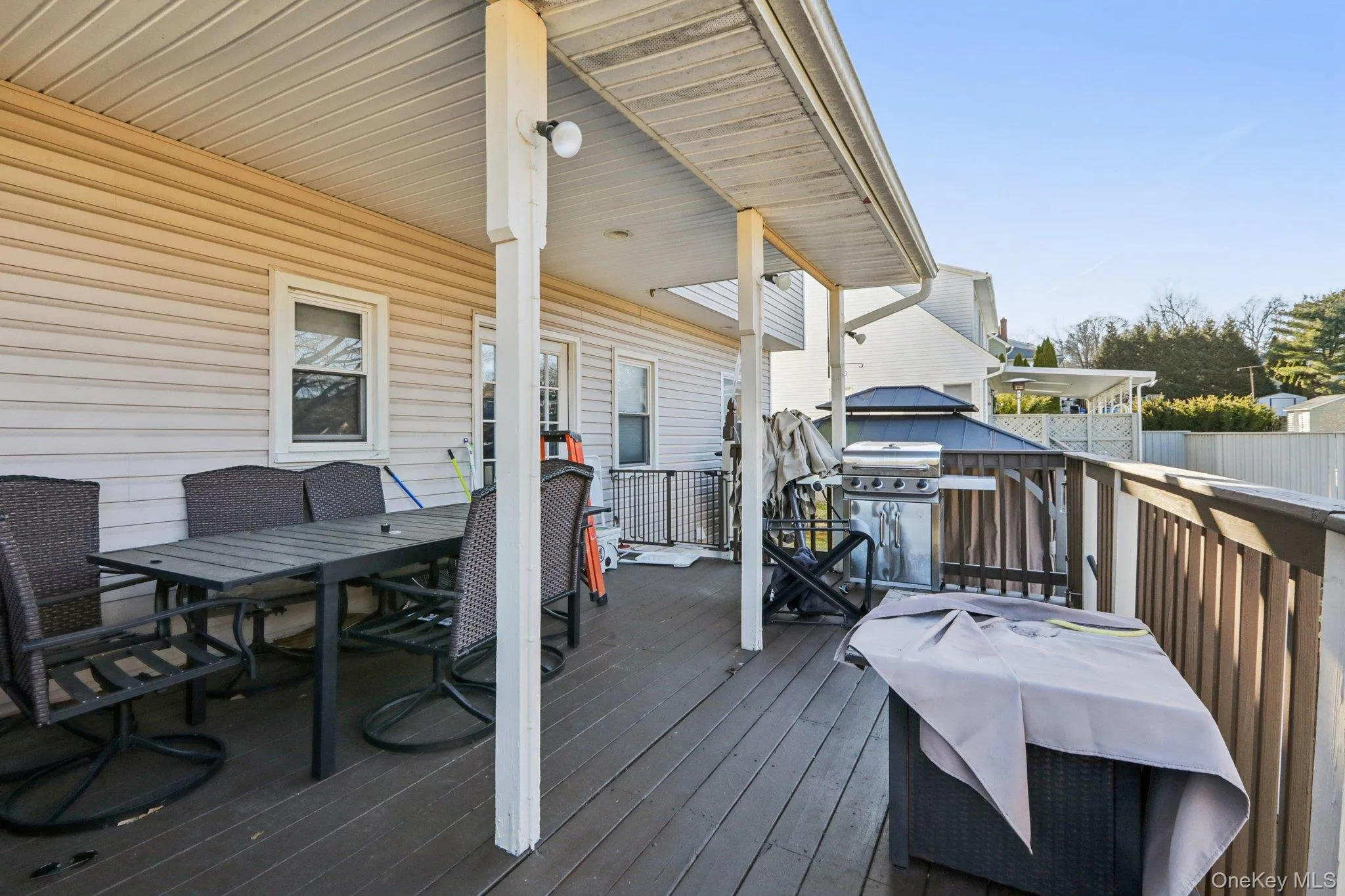 Wooden deck featuring outdoor dining space and grilling area Wooden deck featuring outdoor dining space and grilling area