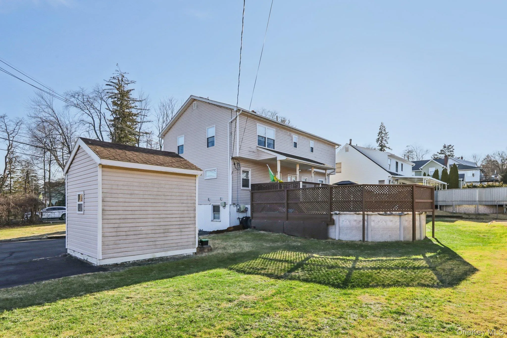Back of house featuring a pool, a yard, and an outdoor structure Back of house featuring a pool, a yard, and an outdoor structure
