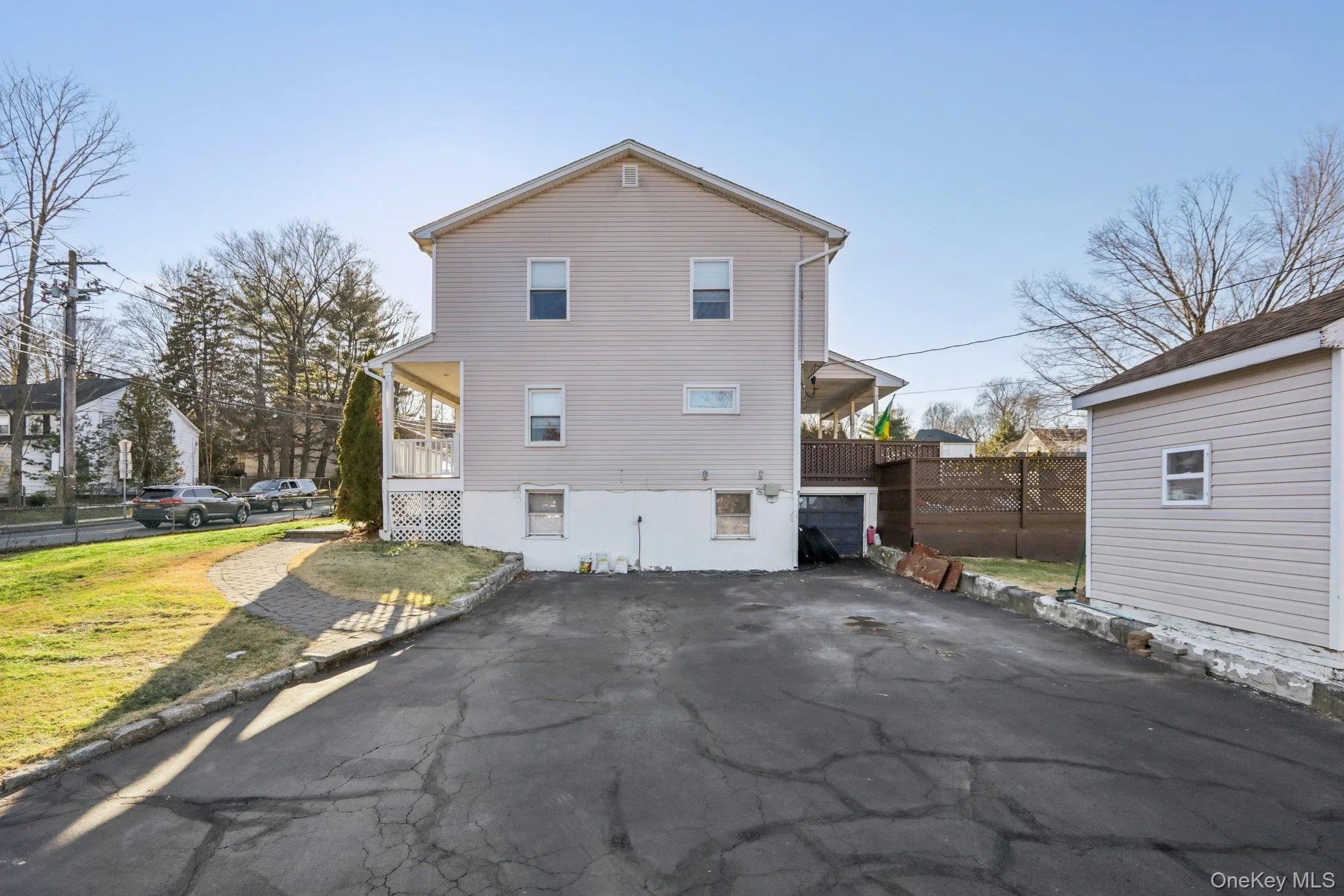 Side of property featuring asphalt driveway and a lawn Side of property featuring asphalt driveway and a lawn