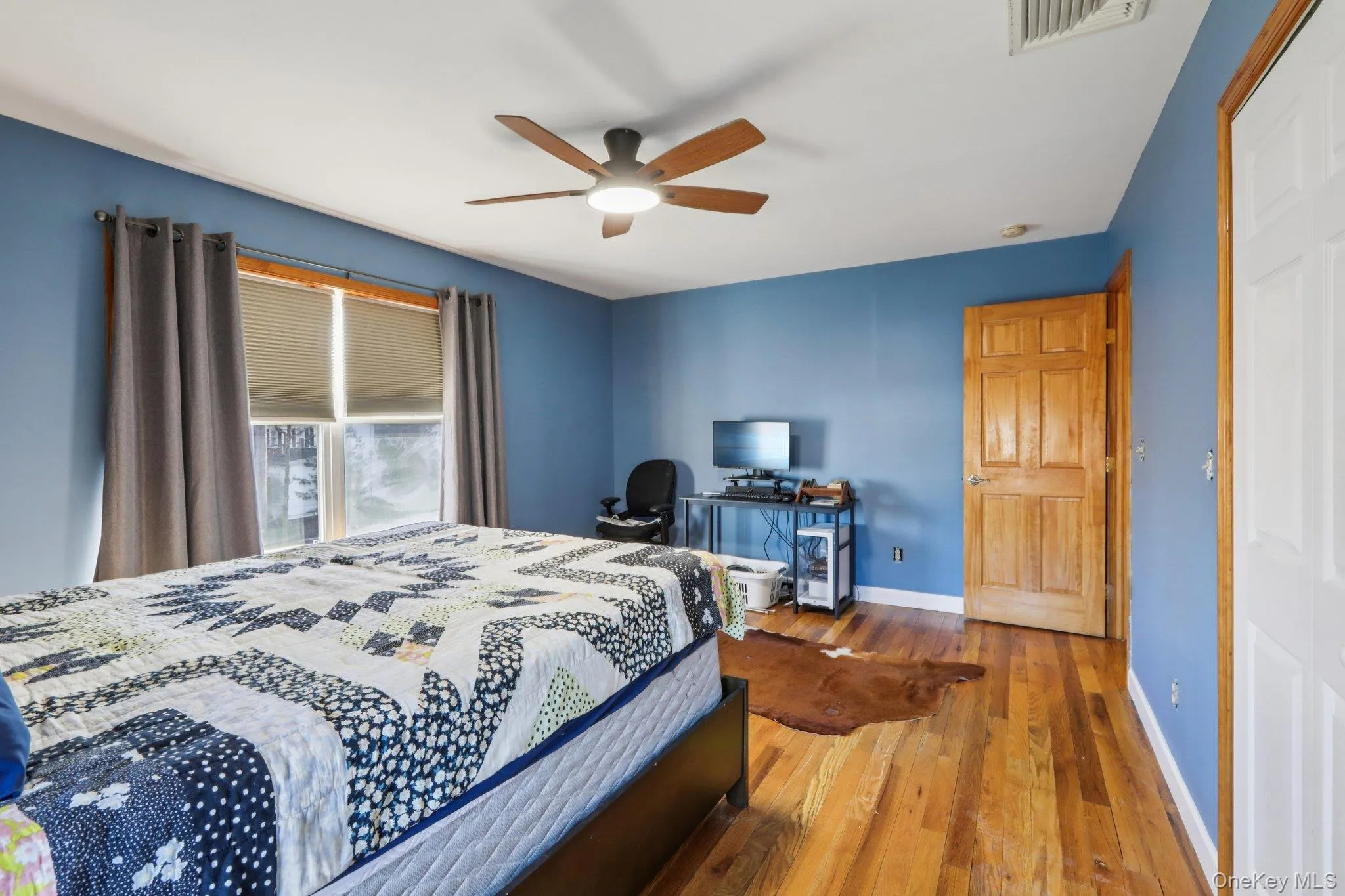 Bedroom with hardwood / wood-style flooring and ceiling fan Bedroom with hardwood / wood-style flooring and ceiling fan