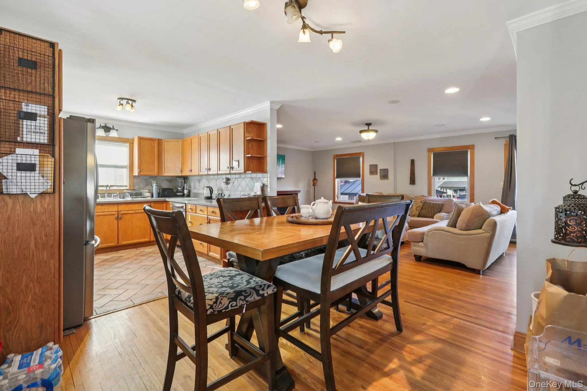Dining room with crown molding, light wood-style flooring, and recessed lighting Dining room with crown molding, light wood-style flooring, and recessed lighting