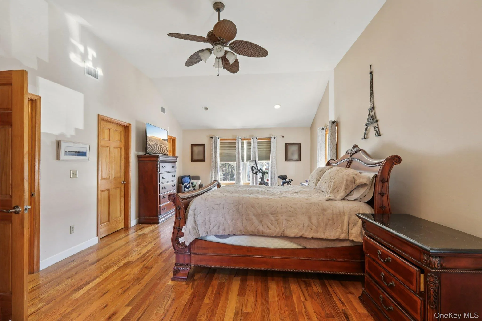 Bedroom with wood finished floors, access to outside, lofted ceiling, and ceiling fan Bedroom with wood finished floors, access to outside, lofted ceiling, and ceiling fan