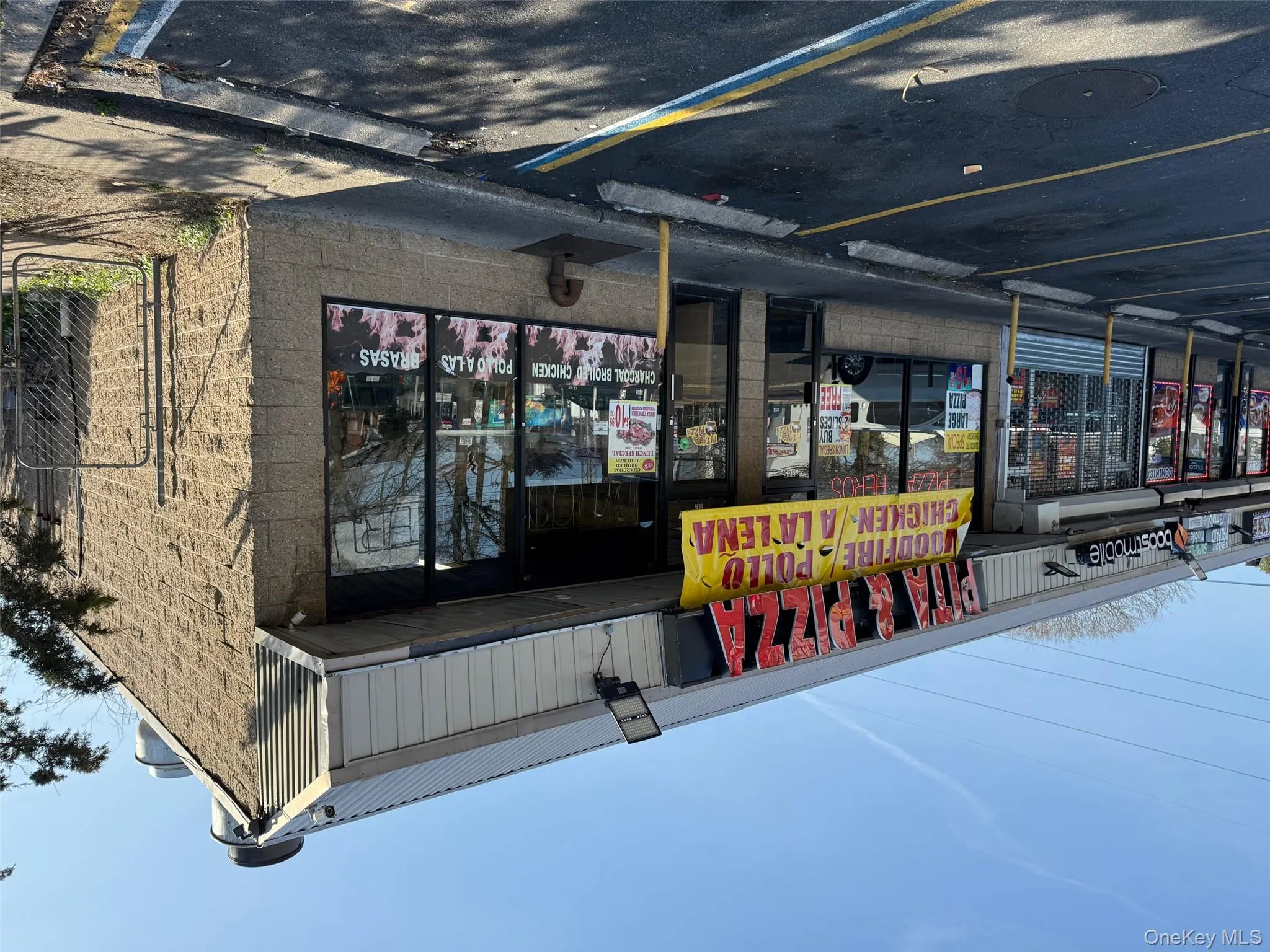 View of building exterior featuring uncovered parking View of building exterior featuring uncovered parking