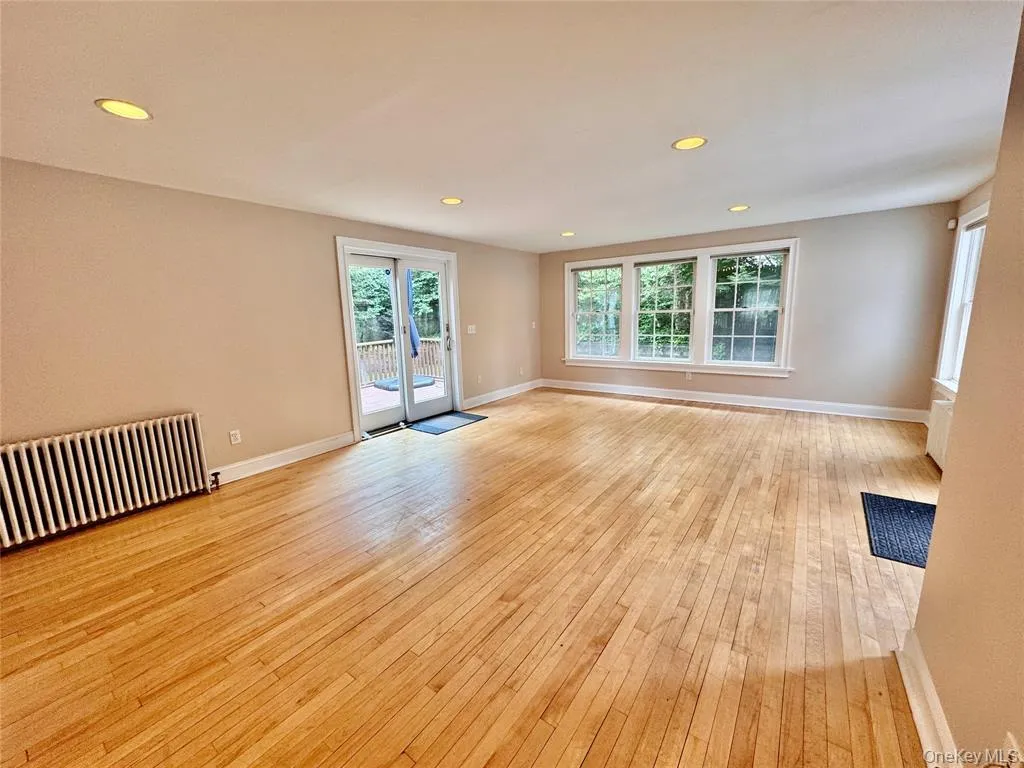 Spacious sunny living room with access to outdoor deck Spacious sunny living room with access to outdoor deck