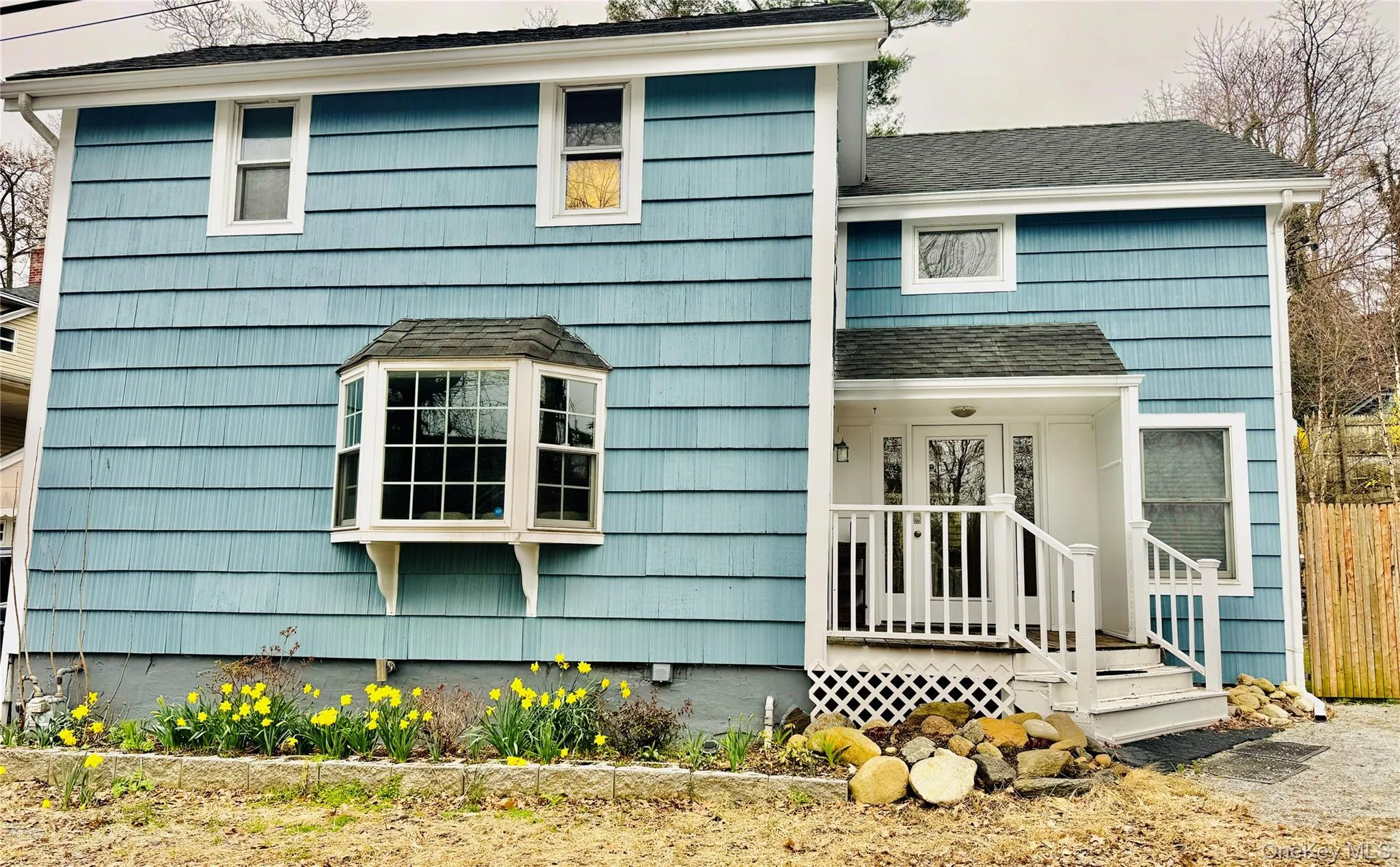Front view of home with daffodils Front view of home with daffodils