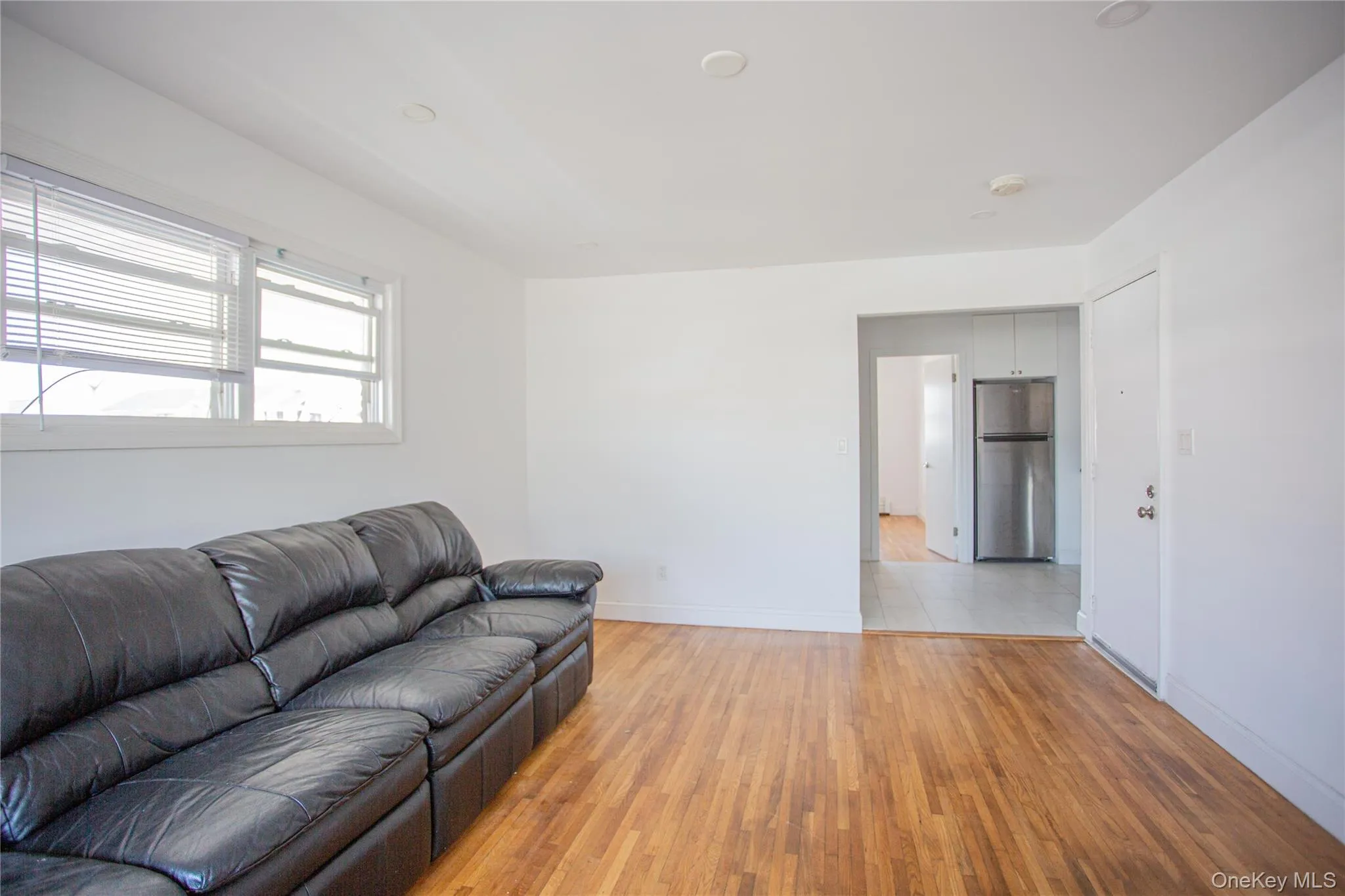 Living room with light wood-type flooring and baseboards Living room with light wood-type flooring and baseboards