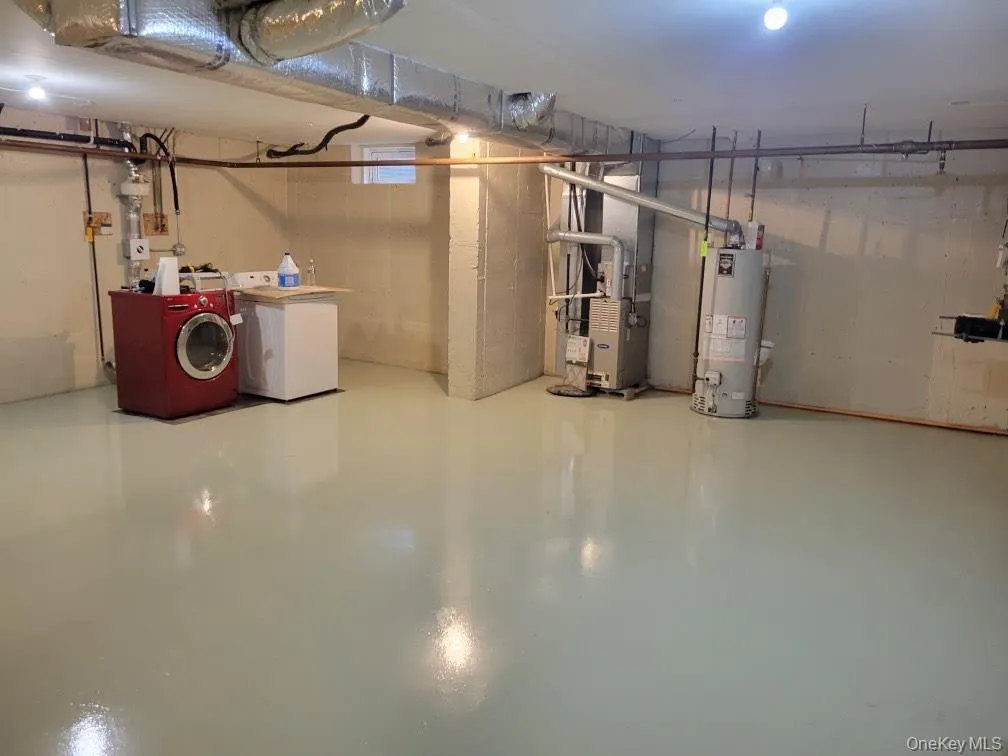 Basement laundry area with washer and dryer Basement laundry area with washer and dryer