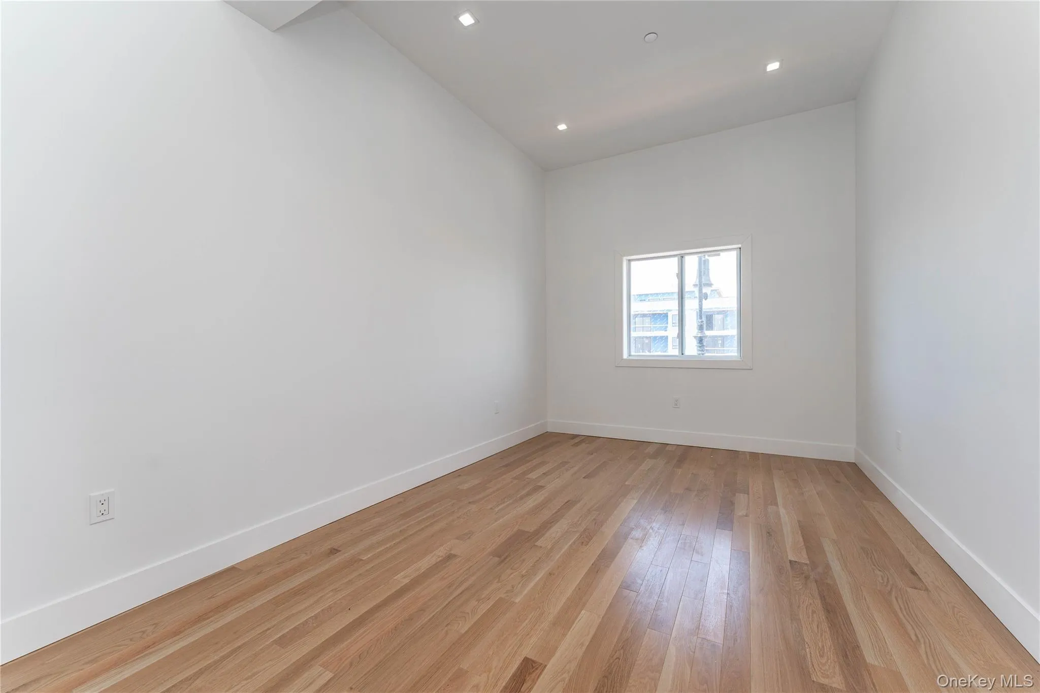 Unfurnished room with light wood-style floors, baseboards, and recessed lighting Unfurnished room with light wood-style floors, baseboards, and recessed lighting