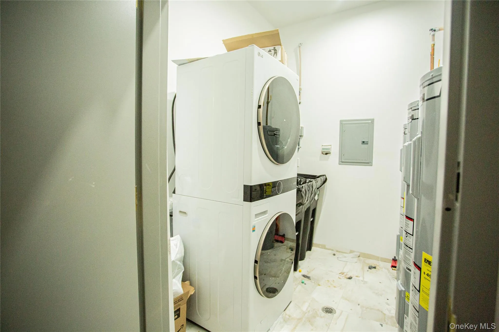 Laundry room with estacked washer and dryer and electric panel Laundry room with estacked washer and dryer and electric panel