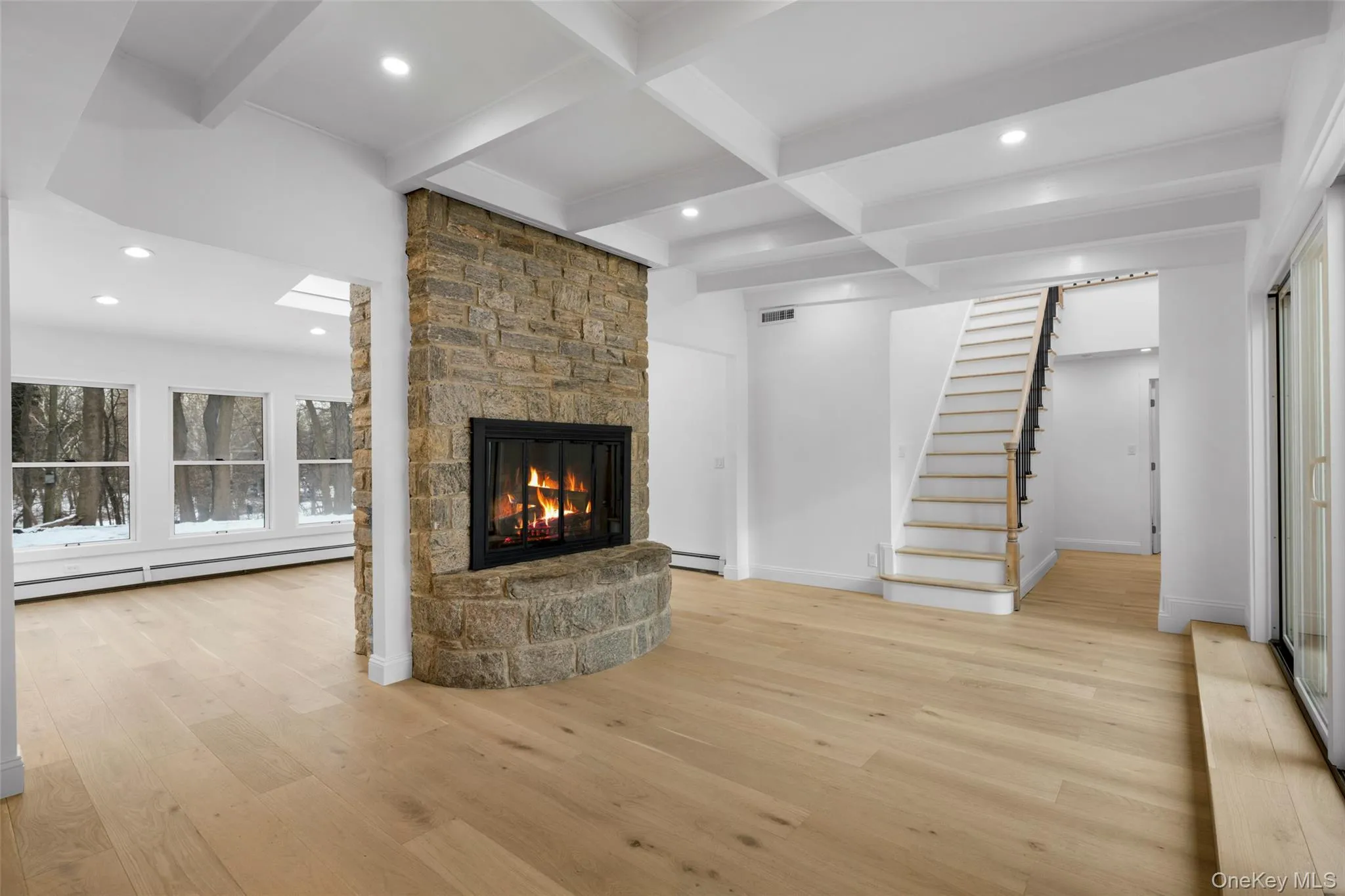 Stunning open-concept layout with a centerpiece stone fireplace. Stunning open-concept layout with a centerpiece stone fireplace.