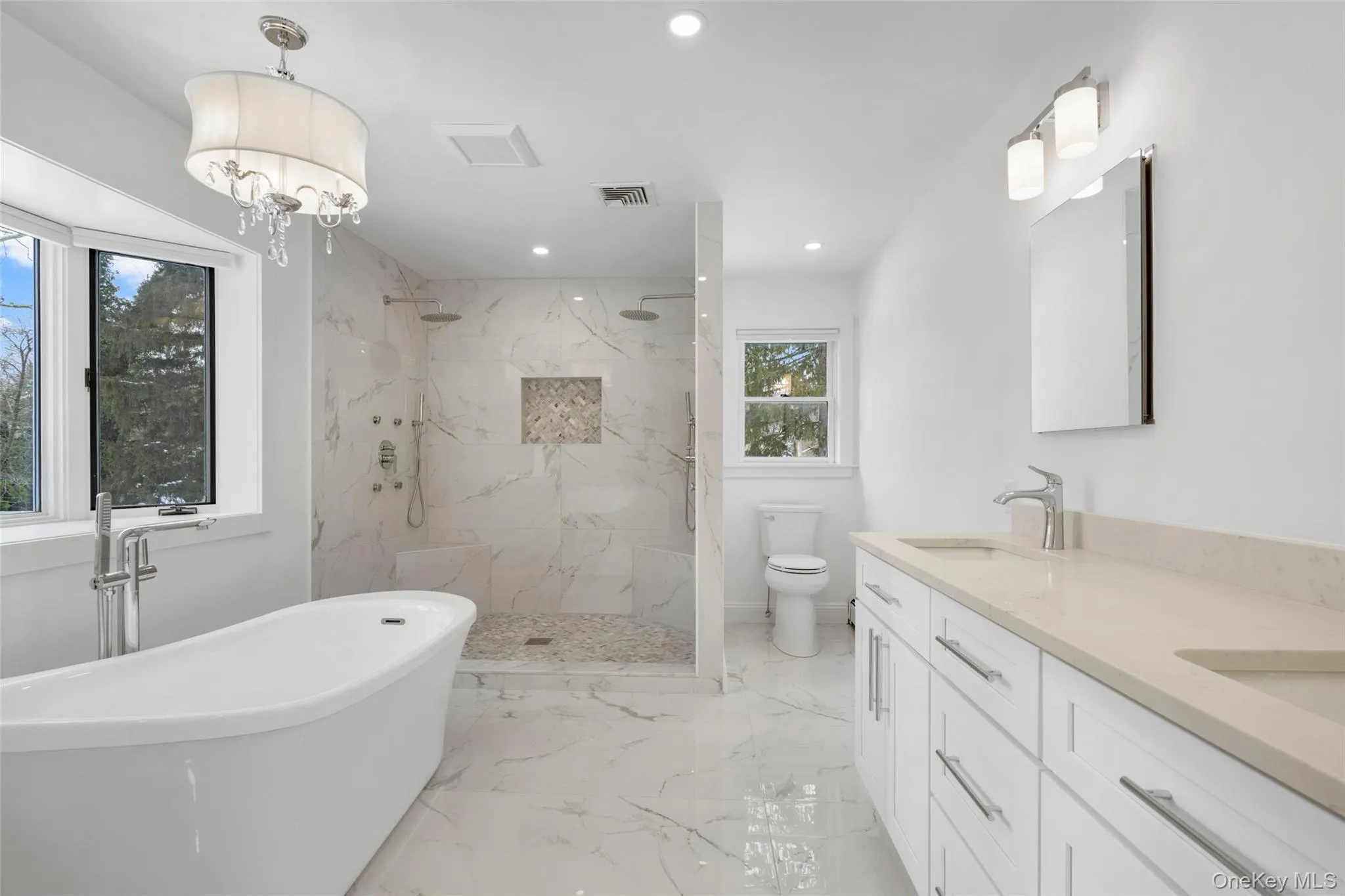 Luxurious soaker tub and a massive walk-in shower equipped with body sprays. Luxurious soaker tub and a massive walk-in shower equipped with body sprays.