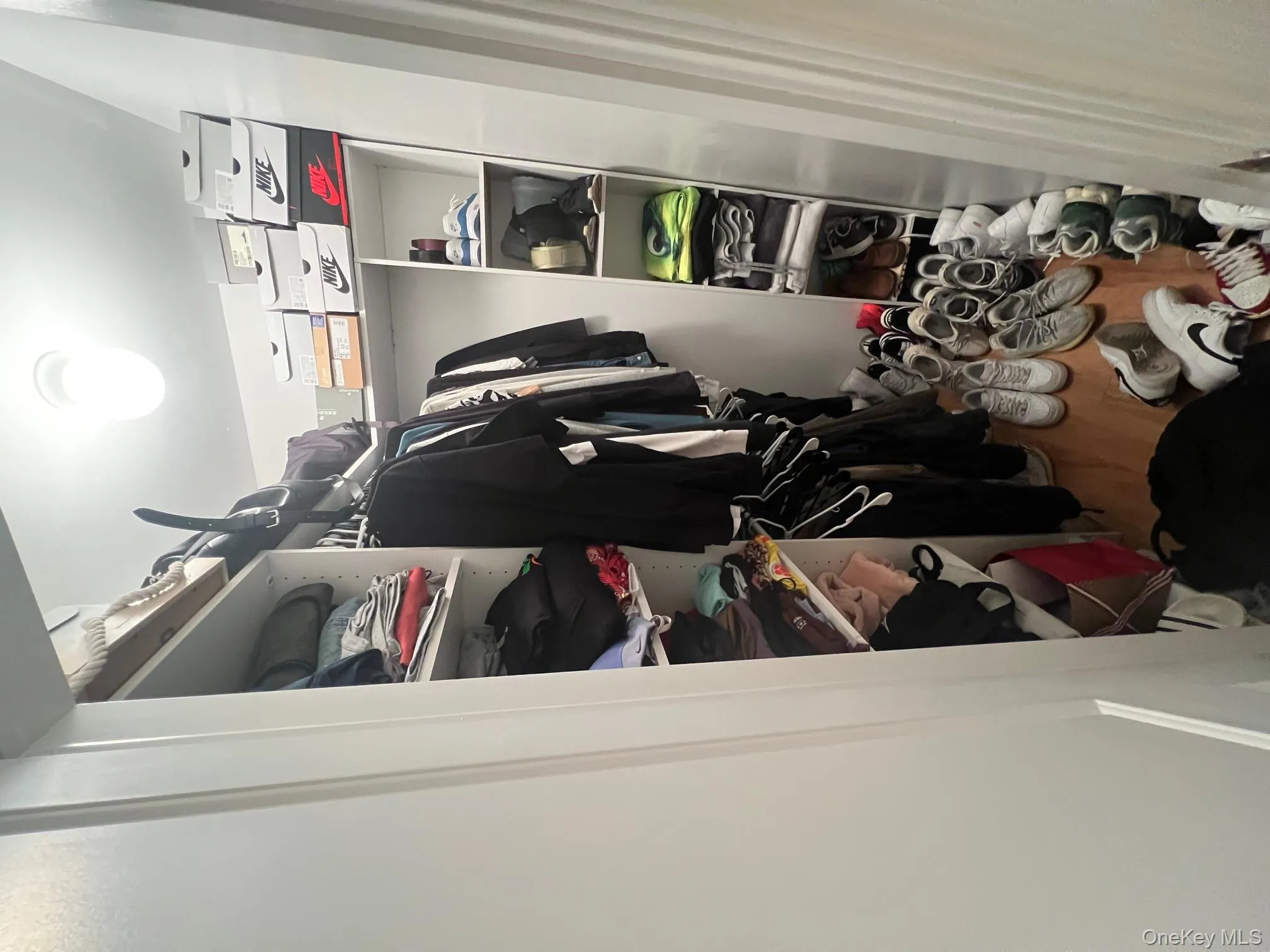 Spacious closet with wood-type flooring Spacious closet with wood-type flooring